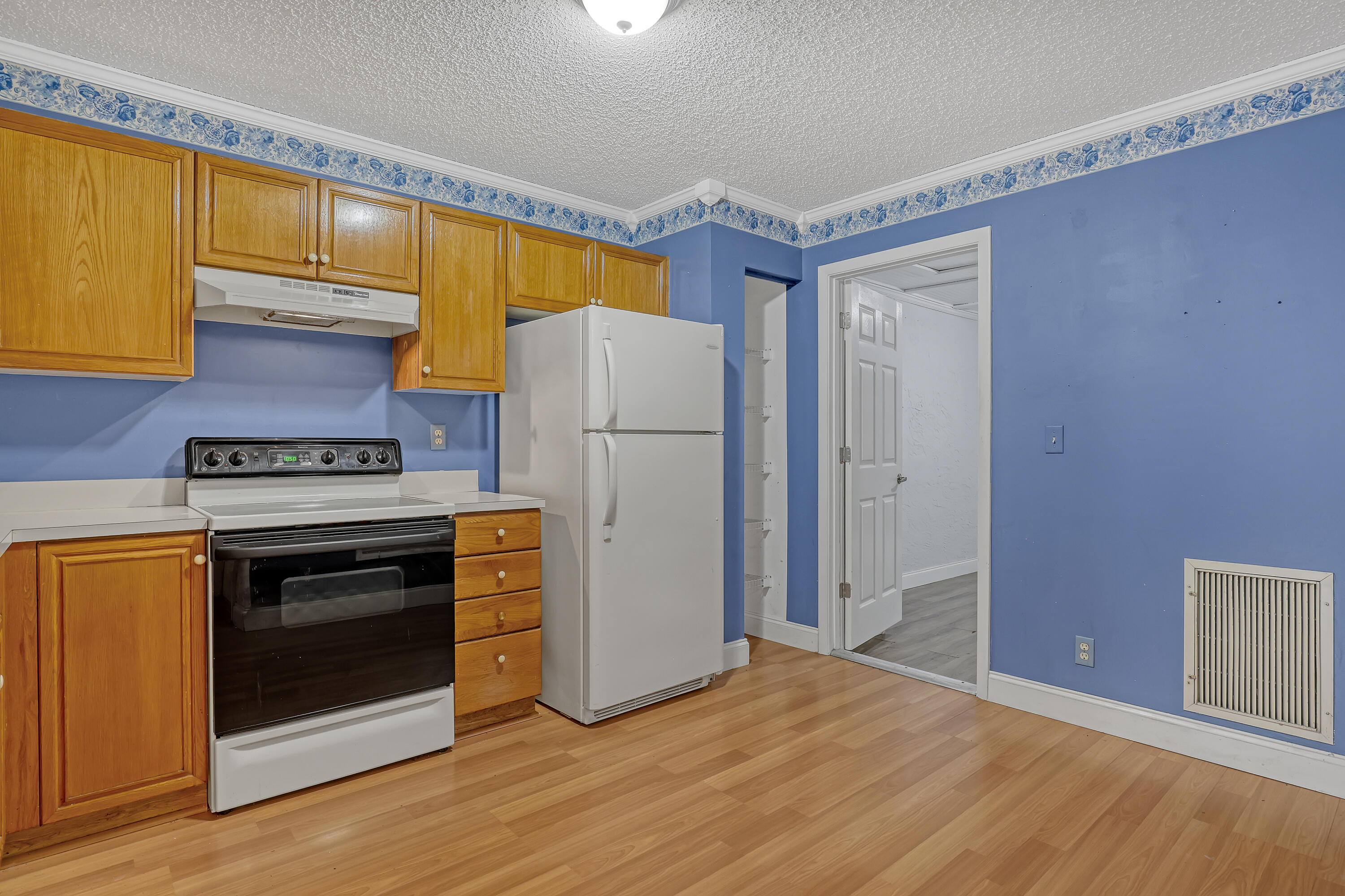 Kitchen with door to extra converted room