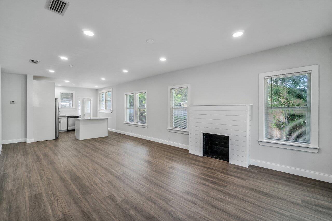 Open living area, fireplace, and high hat lighting.