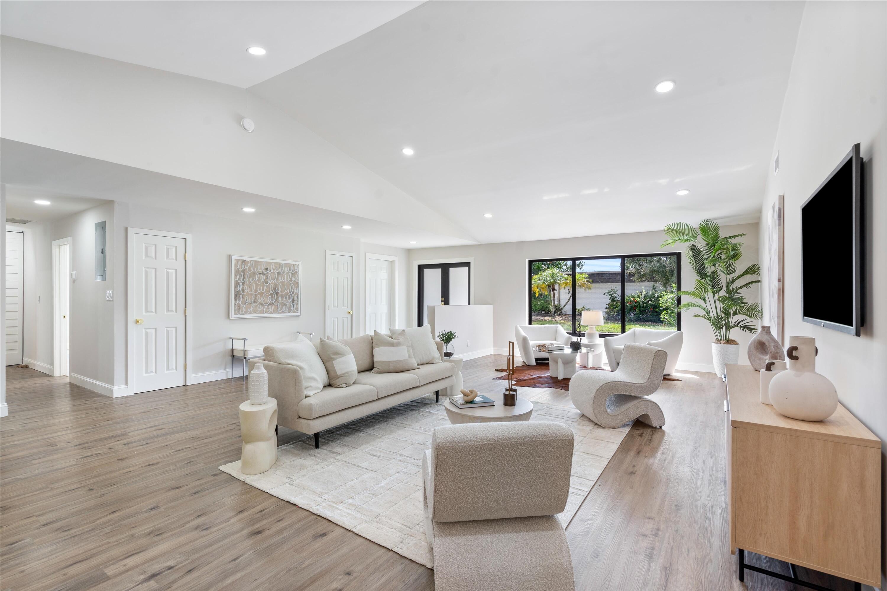 Vaulted ceilings, wood-finish flooring, recessed lighting, and expansive windows Vaulted ceilings, wood-finish flooring, recessed lighting, and expansive windows