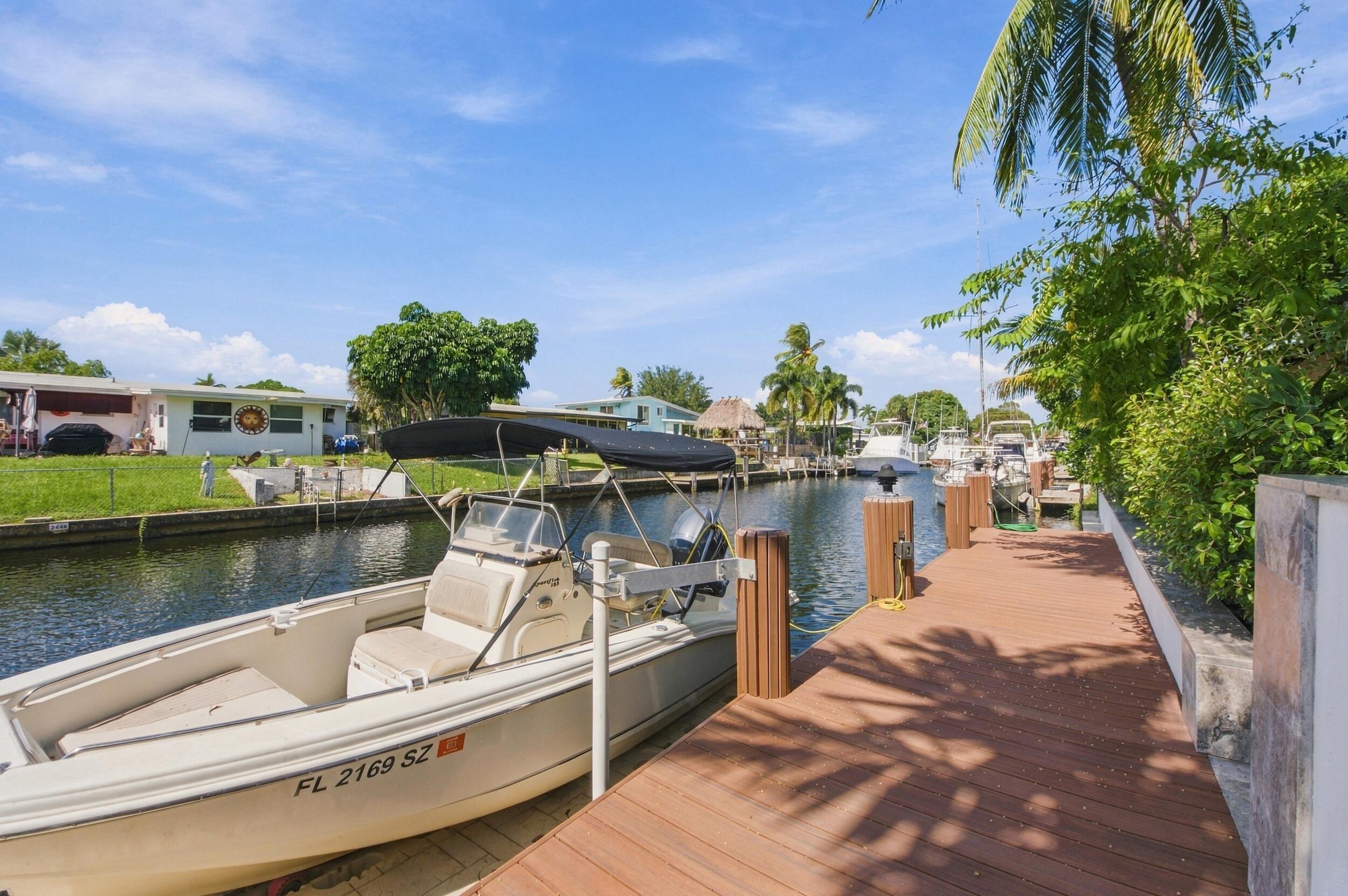 Private canalfront dock featuring composite decking and structural pilings