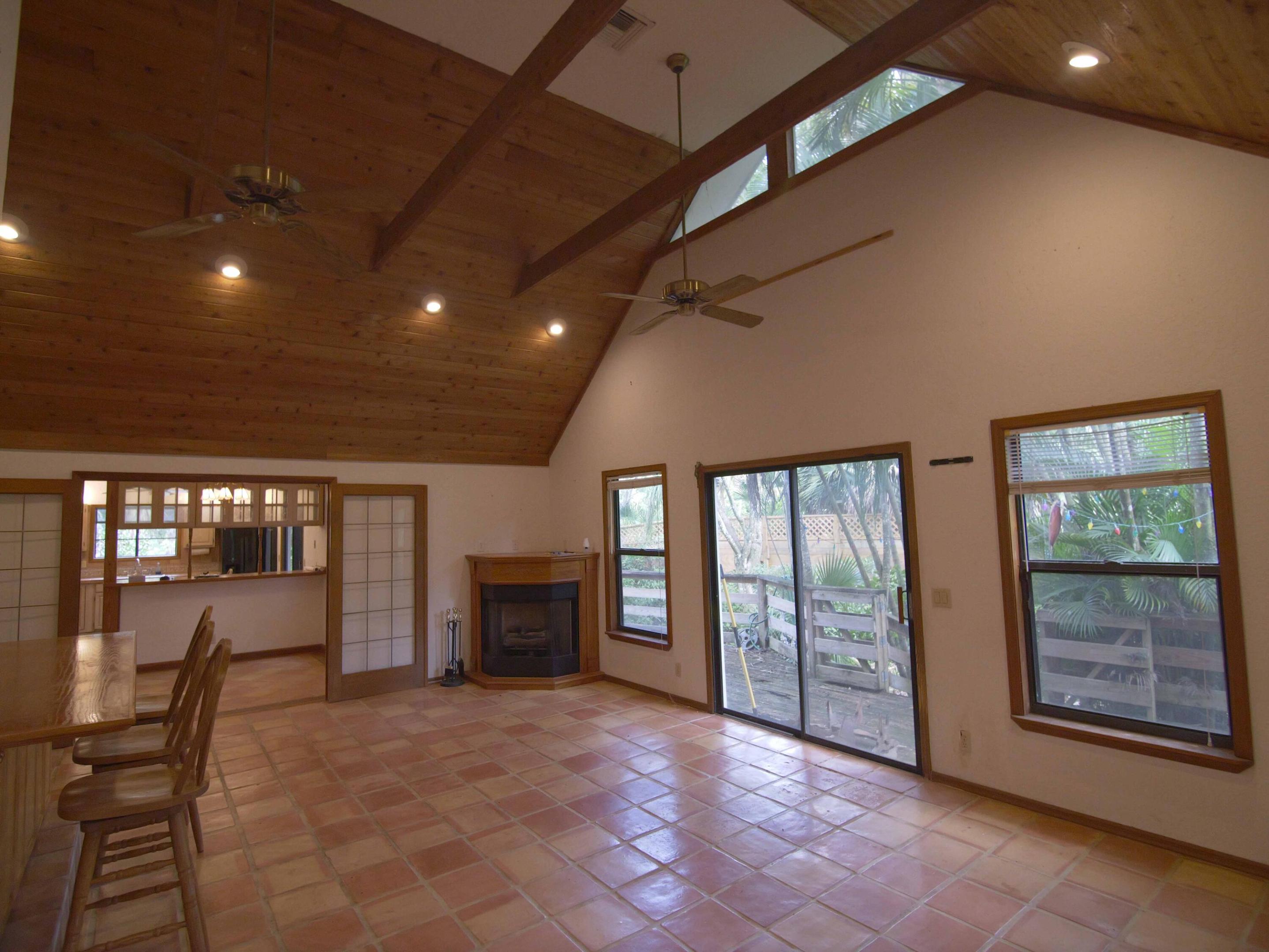 Great Room w/ French doors, fireplace & wrap around deck
