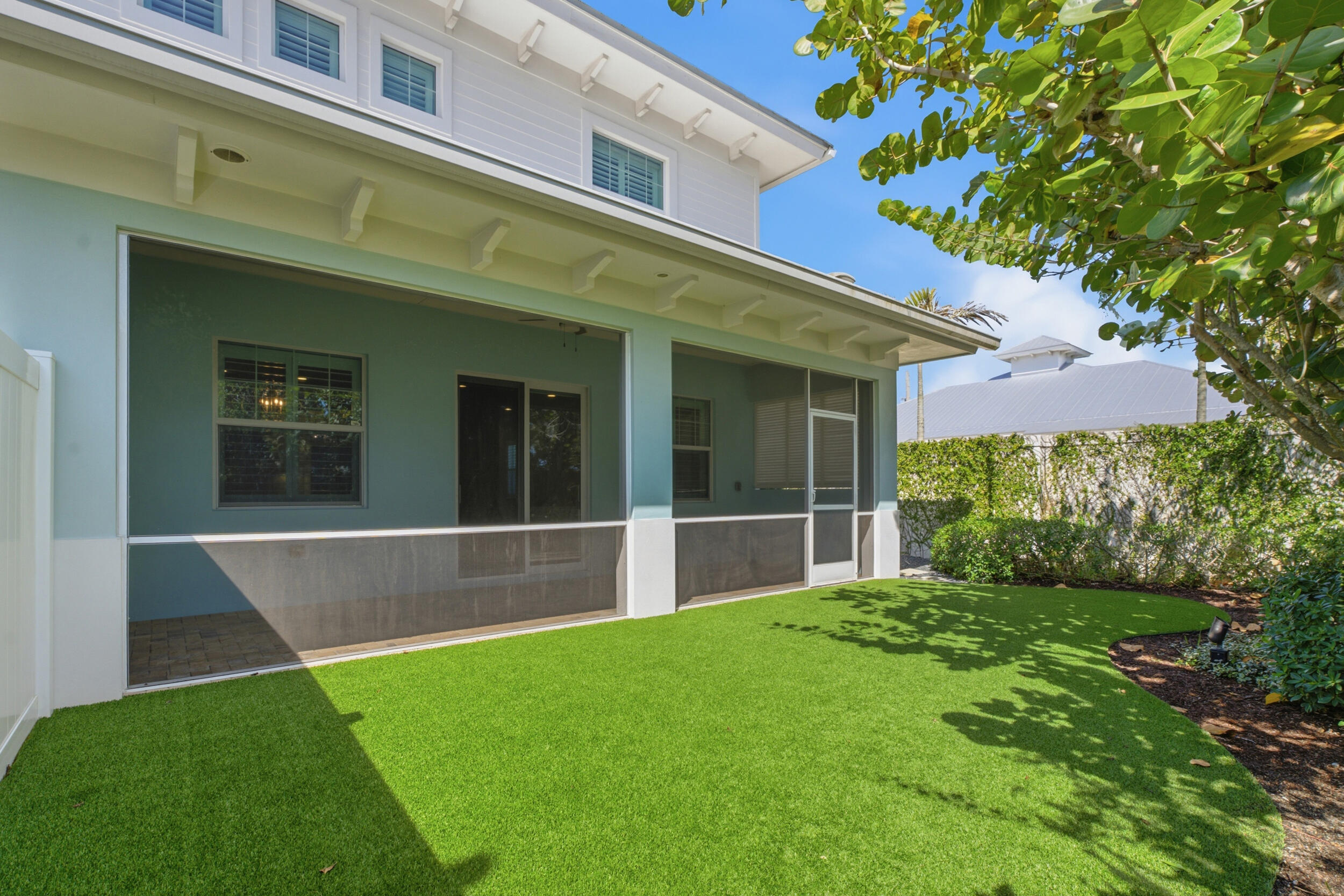 Turf backyard w/ screened in back porch
