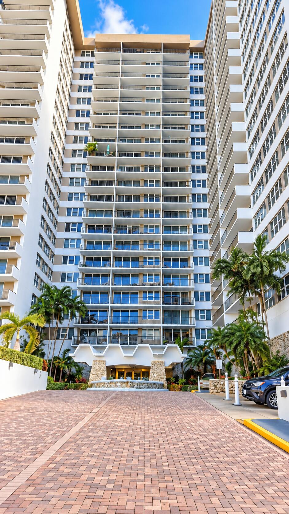 Modern High-Rise Entrance with Palm Land