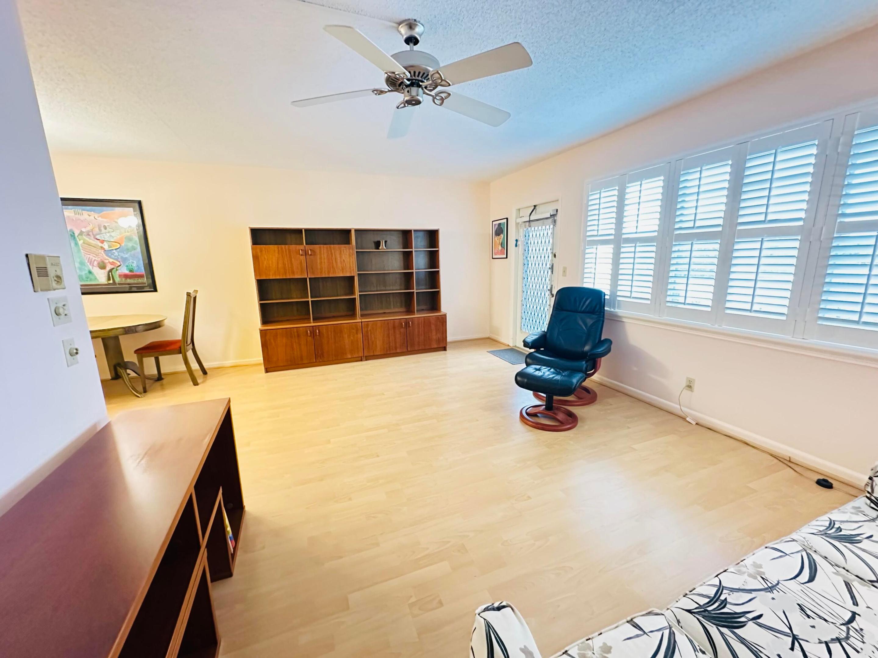 Light laminate flooring, plantationa shutters & ceiling fan with light fixture, and plantation shutters Light laminate flooring, plantationa shutters & ceiling fan with light fixture, and plantation shutters