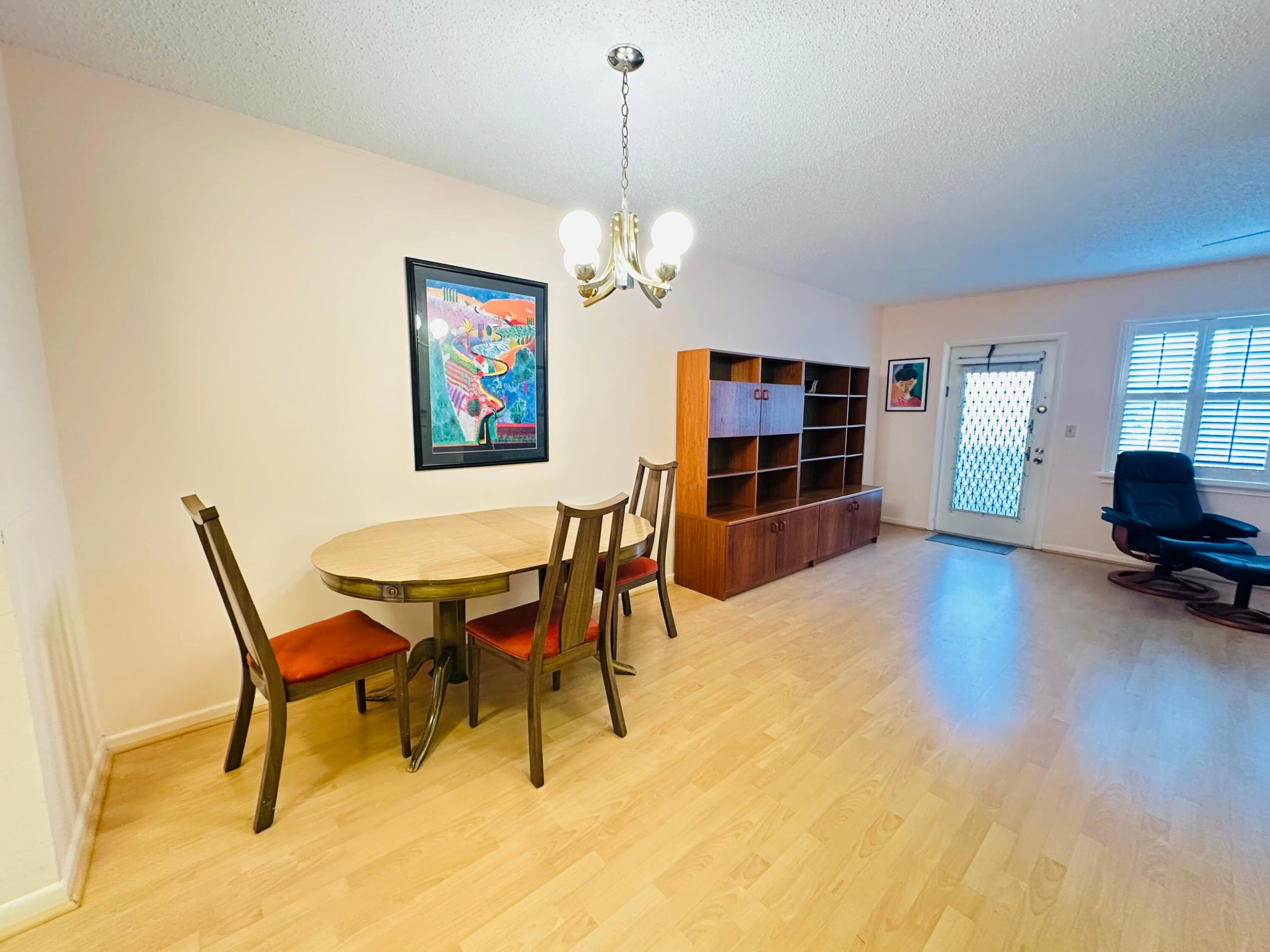 Laminate flooring, multi-bulb metal chandelier, and plantation shutters Laminate flooring, multi-bulb metal chandelier, and plantation shutters