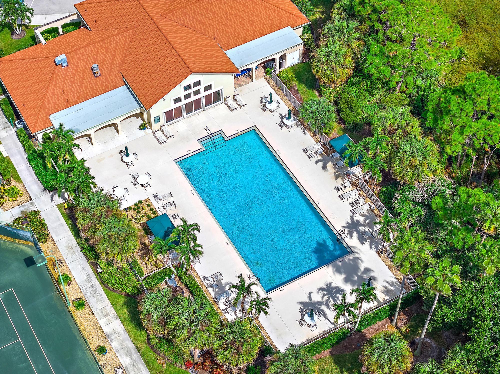 Community Clubhouse featuring multiple tennis courts, pickleball court, and a heated outdoor swimming pool, and gym.