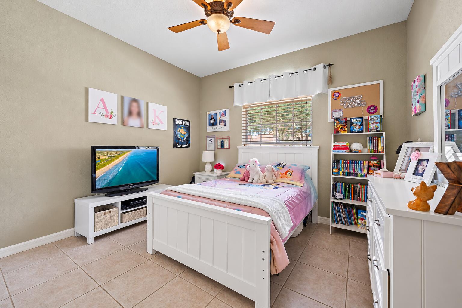 Neutral-toned guest room featuring large-format tile flooring.