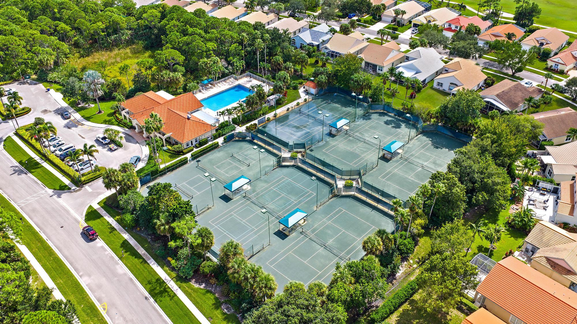 Community Clubhouse featuring multiple tennis courts, pickleball court, a heated outdoor swimming pool, and gym.