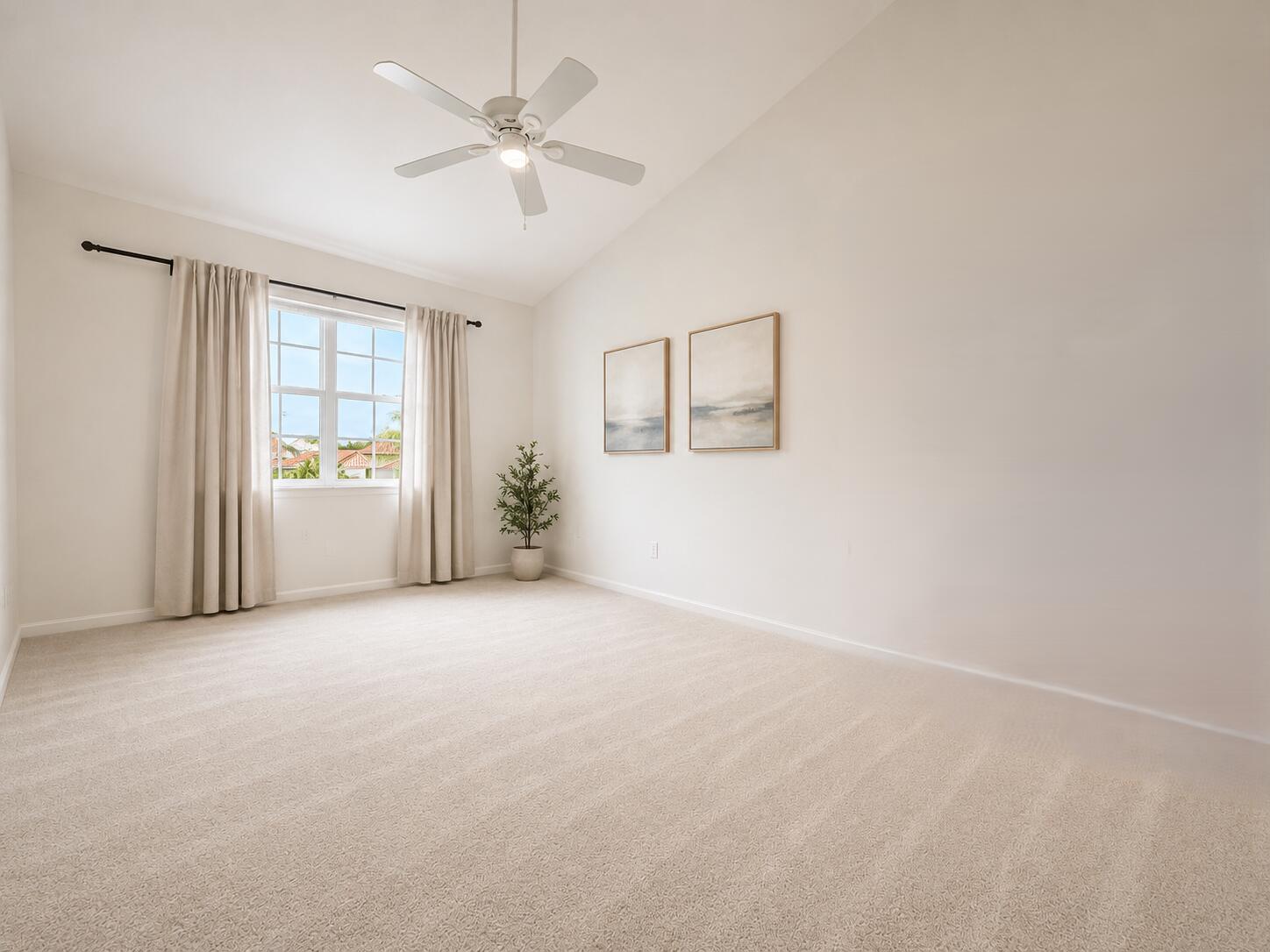 Vaulted ceiling featuring a central light-integrated ceiling fan, carpeted flooring, and a multi-pane window