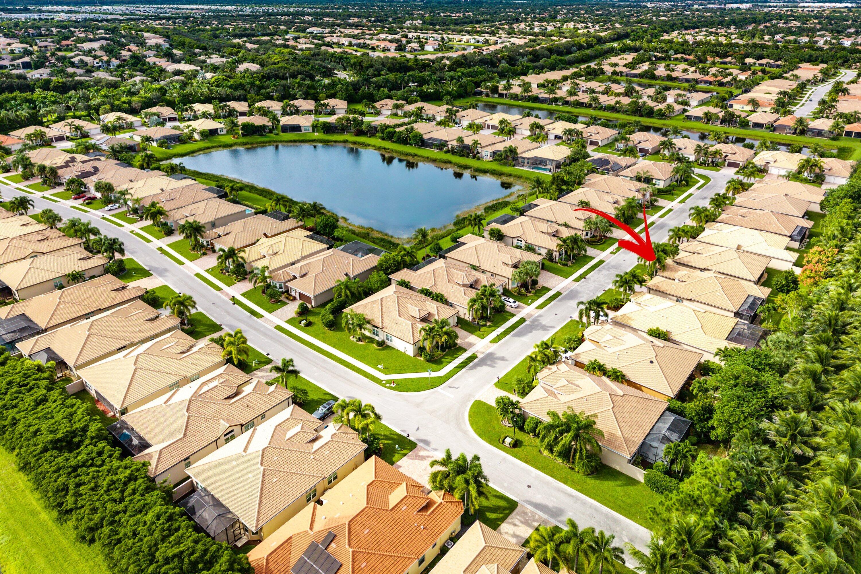Aerial perspective featuring tile roofing, concrete paved streets, and residential landscaping within a suburban community