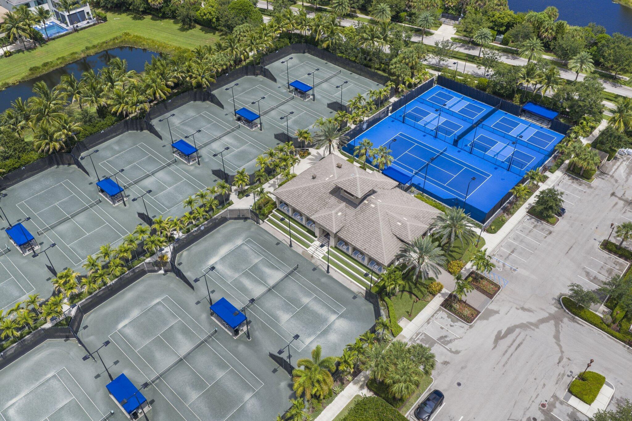 Extensive tennis court complex featuring multiple courts, a central clubhouse, and ample surrounding landscaping