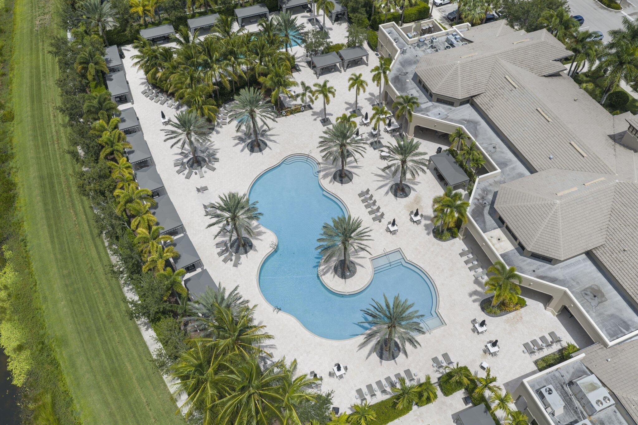 Expansive resort-style pool with integrated spa, surrounded by a paved deck