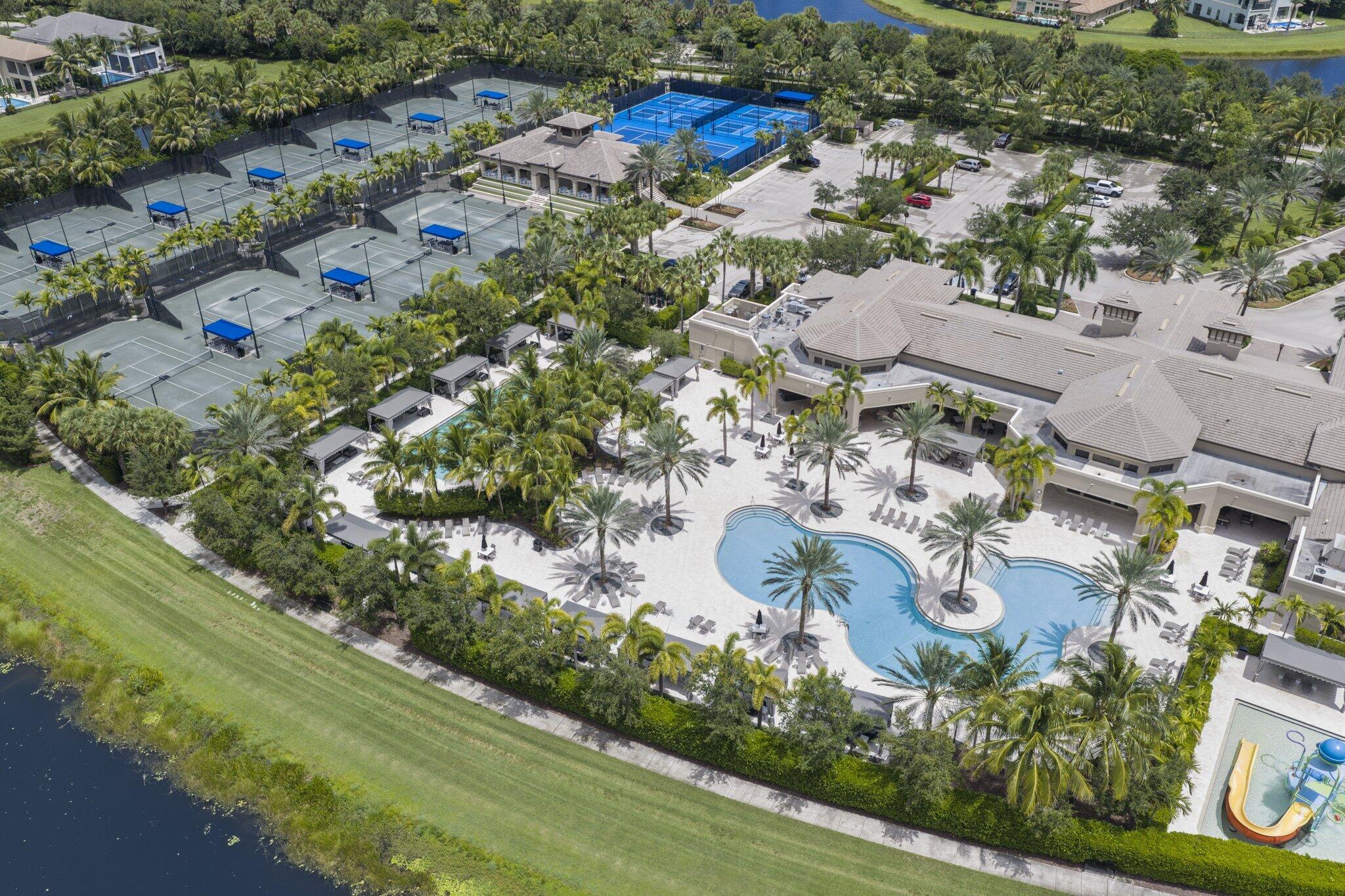 Extensive tennis courts, multiple pickleball courts, large swimming pool with integrated spa, main clubhouse building, and lush tropical landscaping