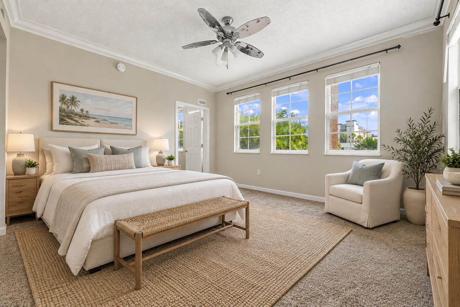 Bedroom featuring neutral walls, triple-pane windows with muntins, and a ceiling fan with integrated lighting