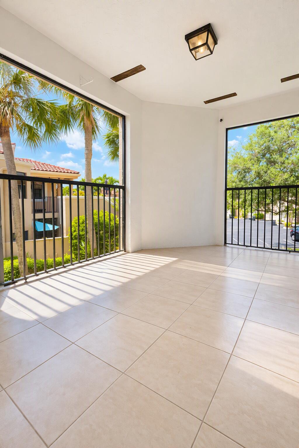 Covered balcony featuring large-format tile flooring, and a flush-mount light fixture
