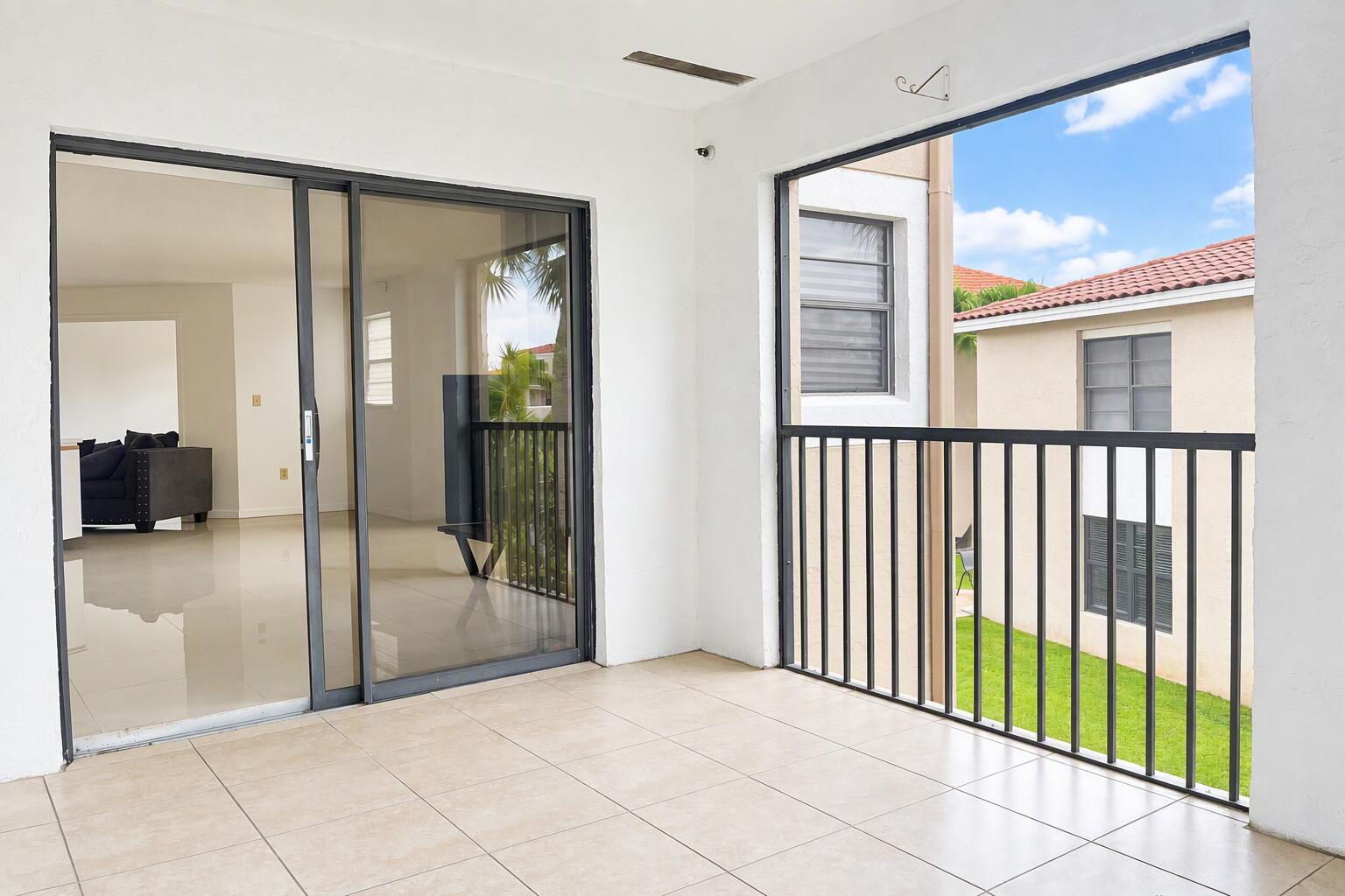 Covered balcony featuring large-format tile flooring, and a sliding glass door entry