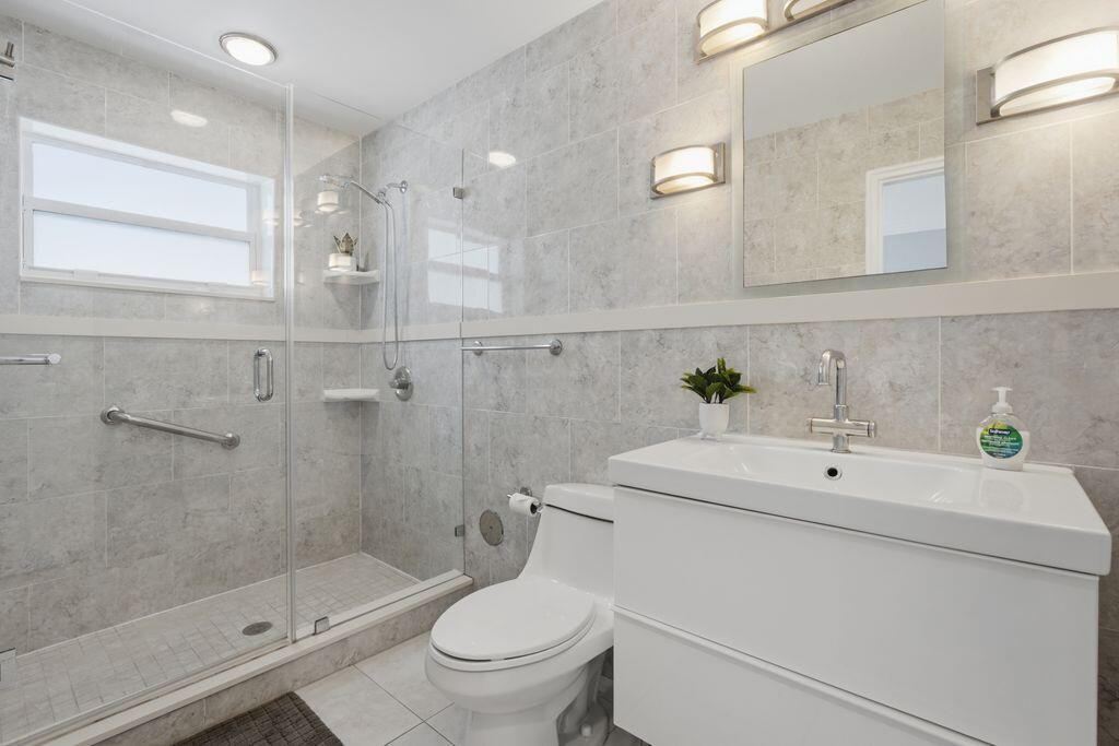 ALL TILED BATH WITH LARGE STEP IN SHOWER-GLASS DOOR