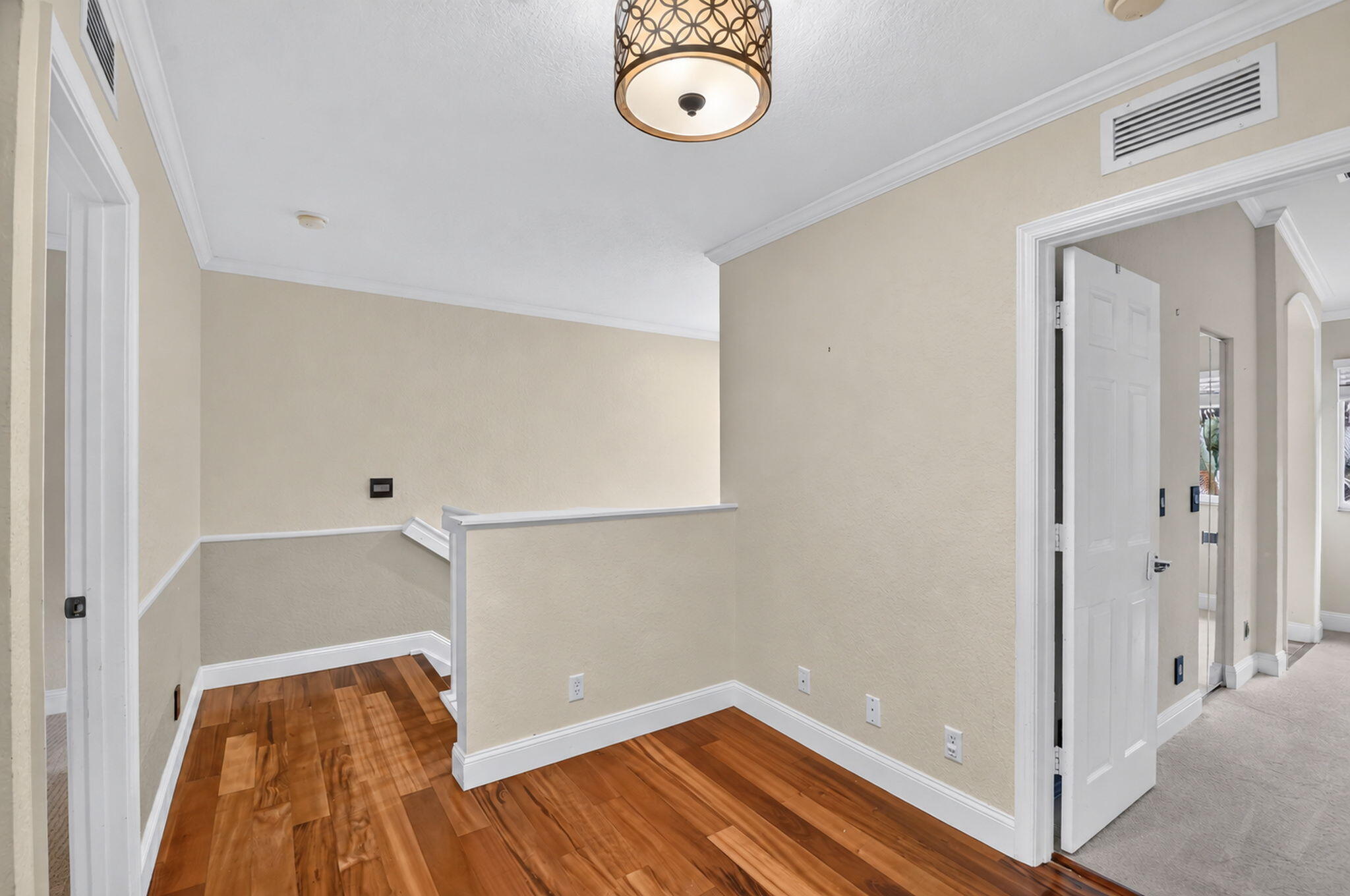 Wood floors on landing and stairs.