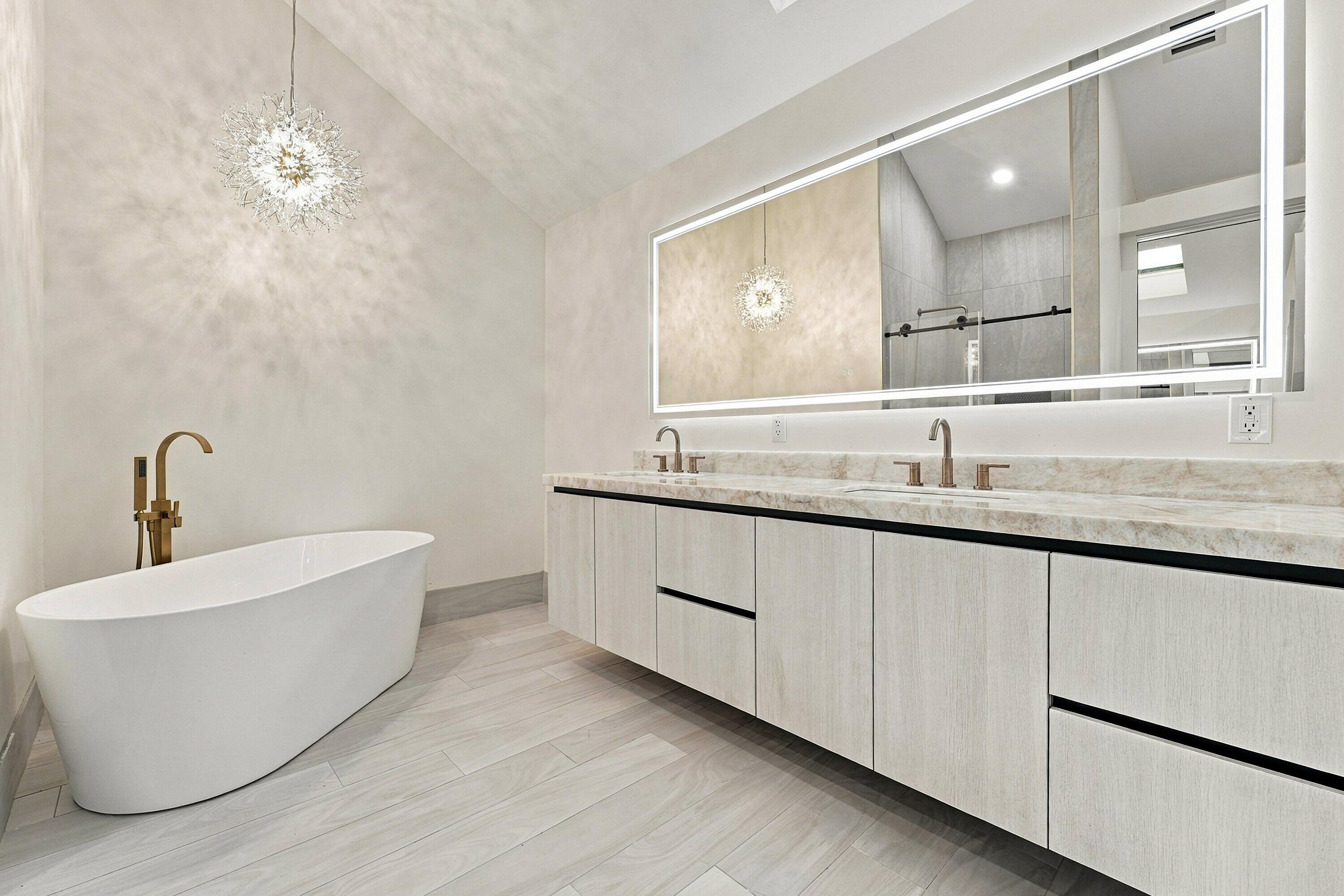 Gorgeous primary bathroom with free standing soaking tub and crystallo quartzite countertops