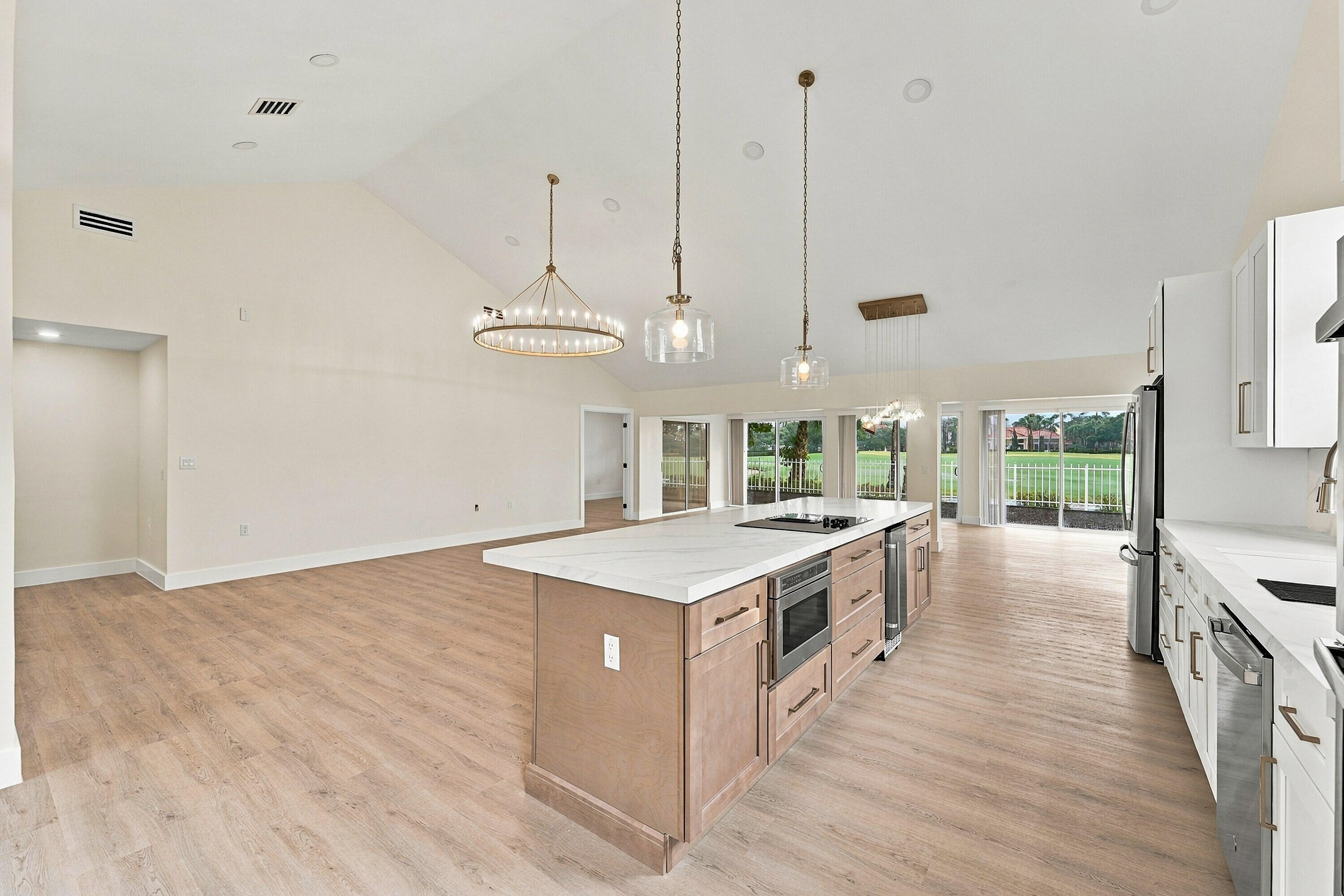 Custom chef's kitchen with brand new GE appliances and beautiful gold accents throughout