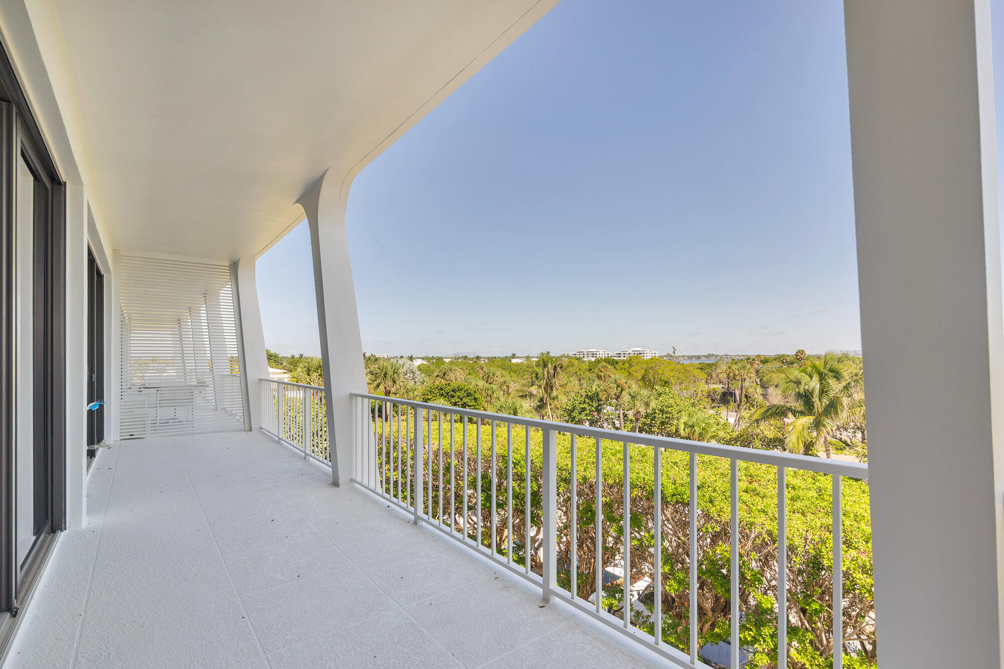 Expansive covered balcony spans the width of the living area and bedrooms
