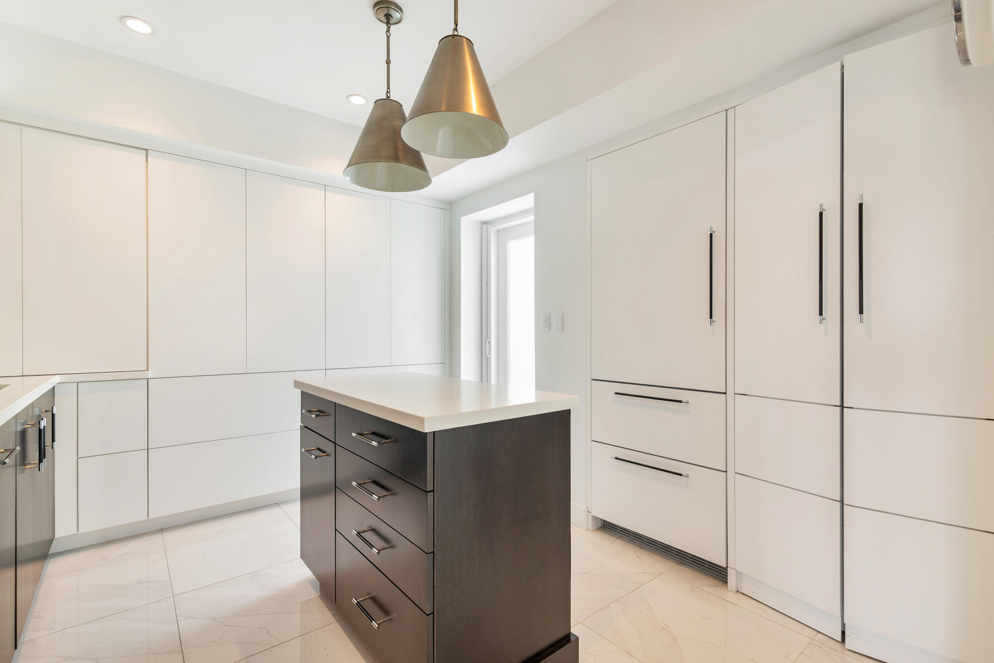 Sleek custom Kitchen with concealed Washer & Dryer