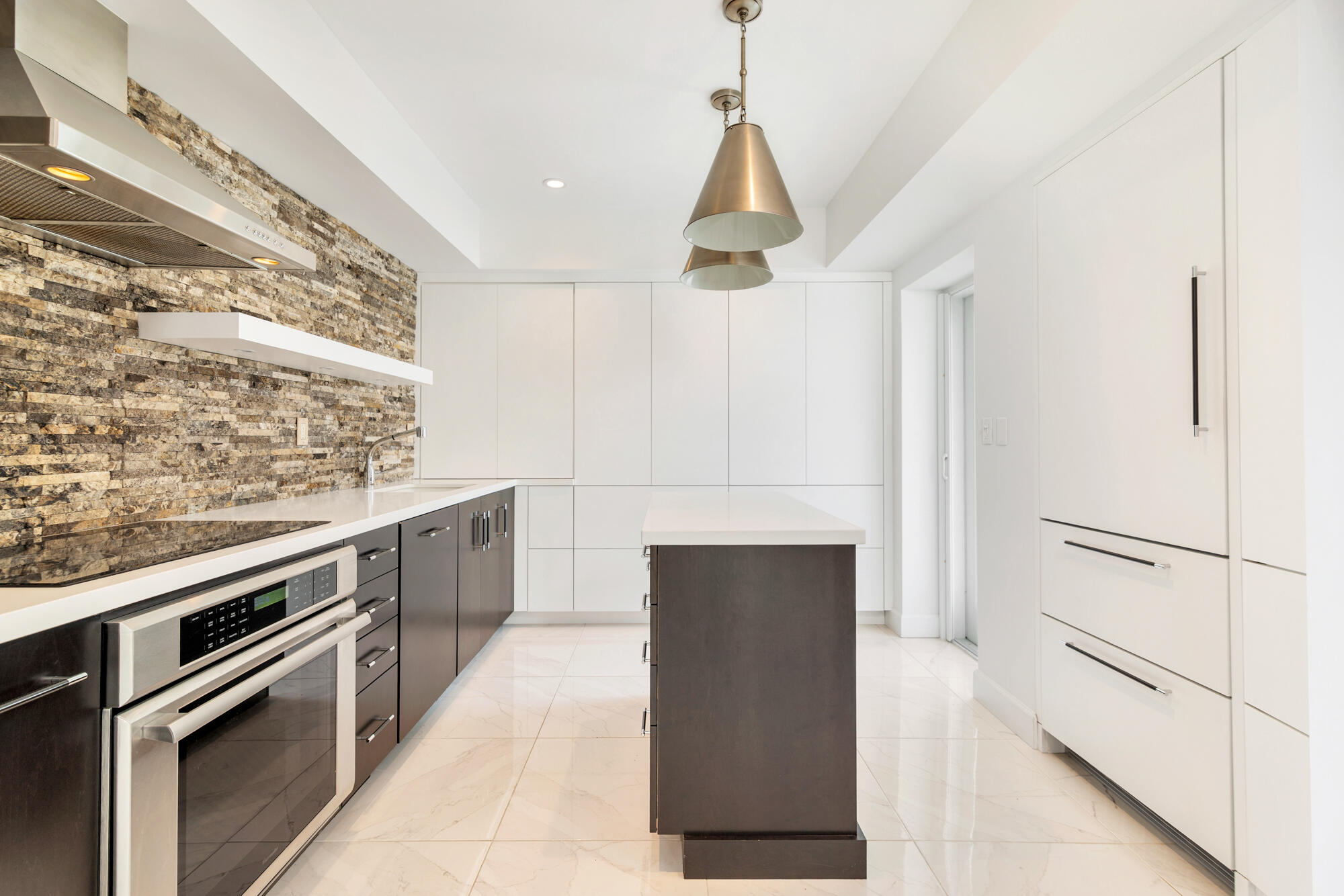 Sleek custom Kitchen with a service entrance door