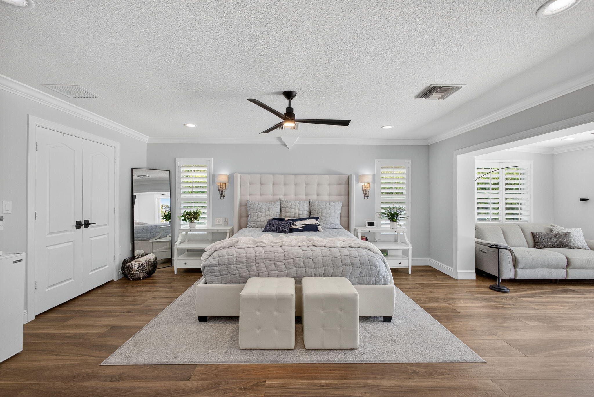 Wood-finish flooring, recessed lighting, crown molding, double doors, and interior plantation shutters