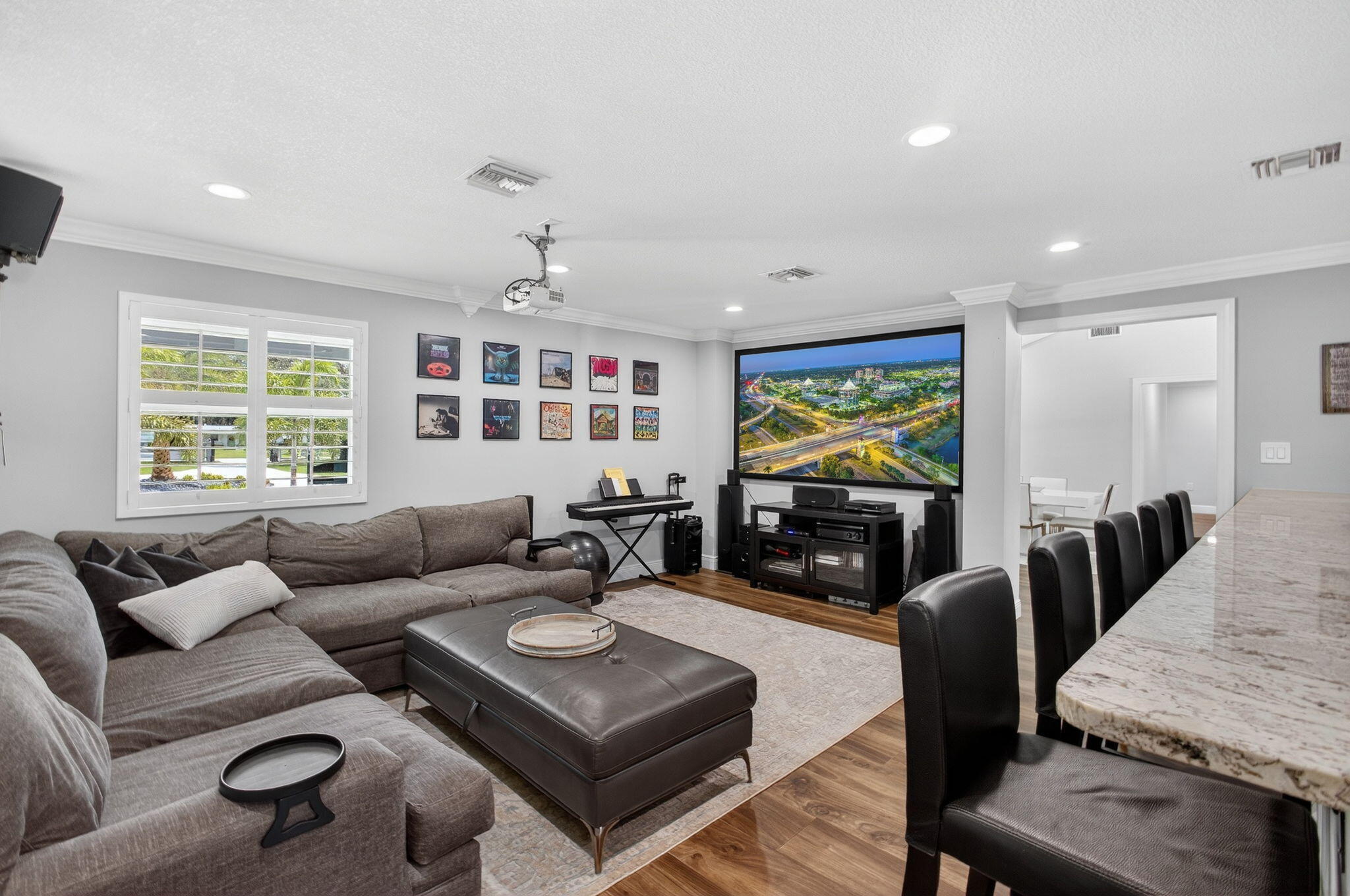 Wood-finish flooring, recessed lighting, crown molding, and plantation shutters
