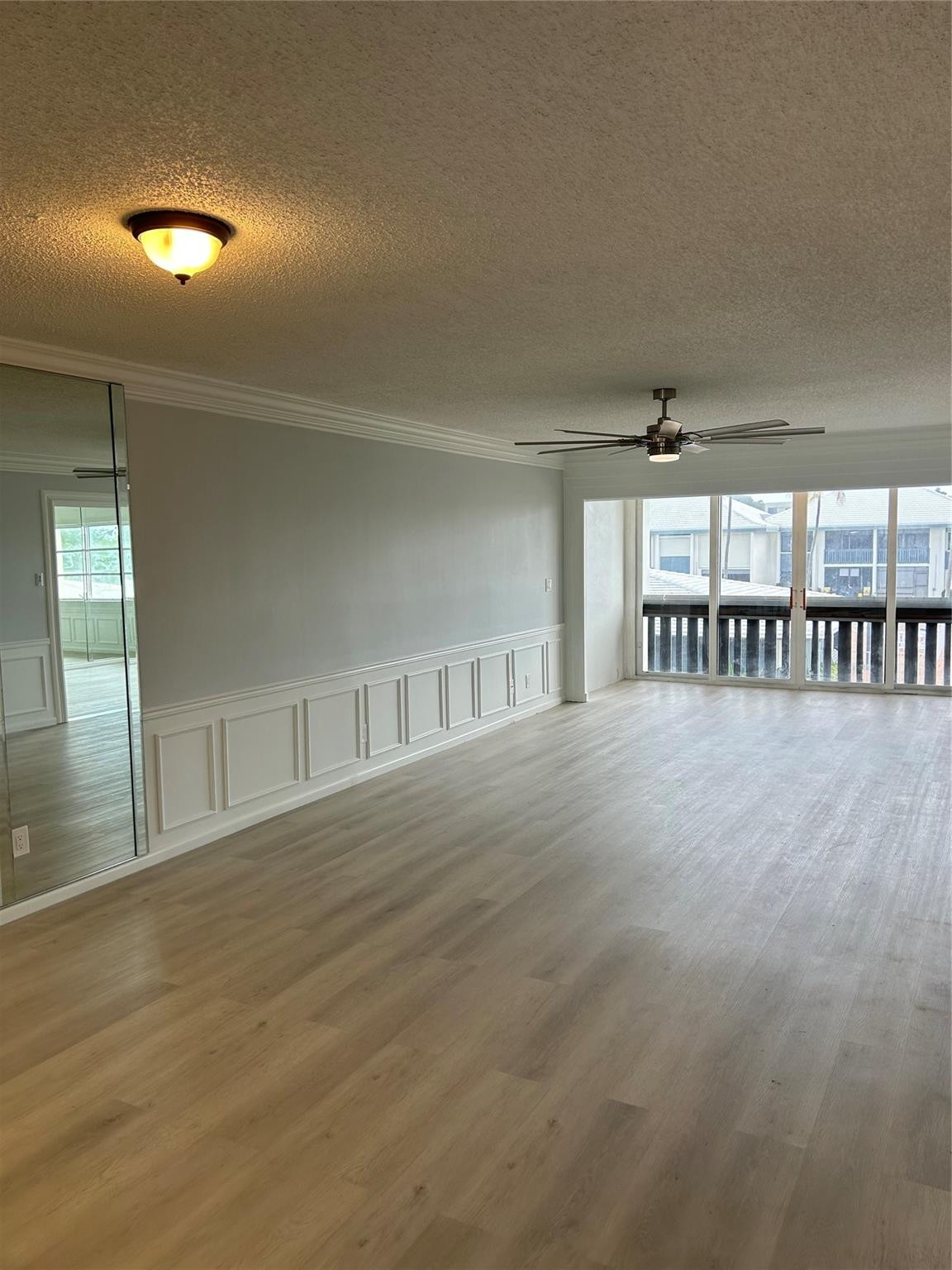 Living Room/ Family Room:Brand new flooring just installed. Custom moldings (wainscoting) / wood work throughout the unit. View from balcony/ patio/ sun room looks over the St. Lucie River, pier, club house, pool, and shuffle board.