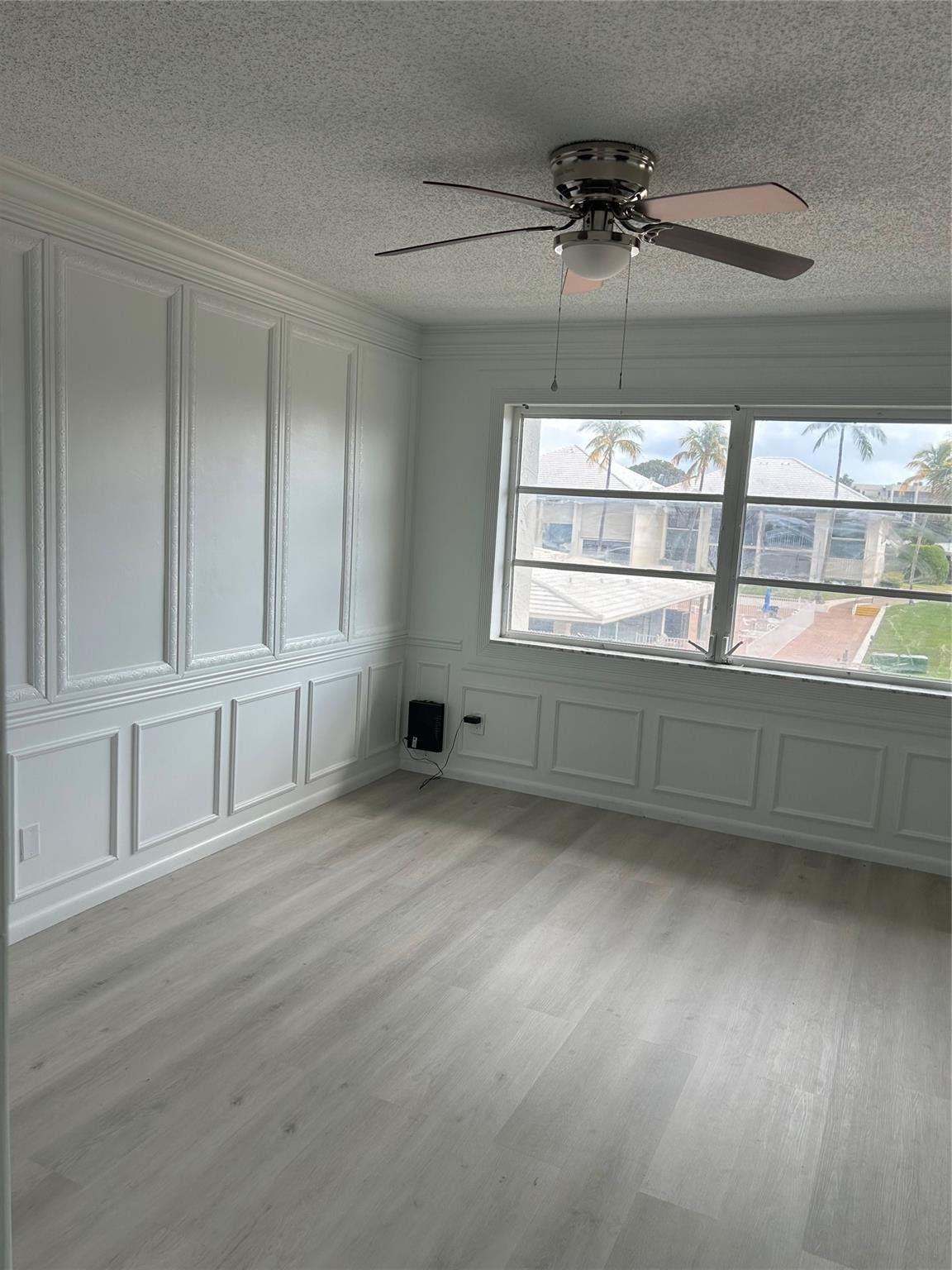 Huge Master Bedroom - custom wood work ( wainscoting), view of the St. Lucie River, club house, pool, etc. 3 different closet spaces! New flooring just installed.