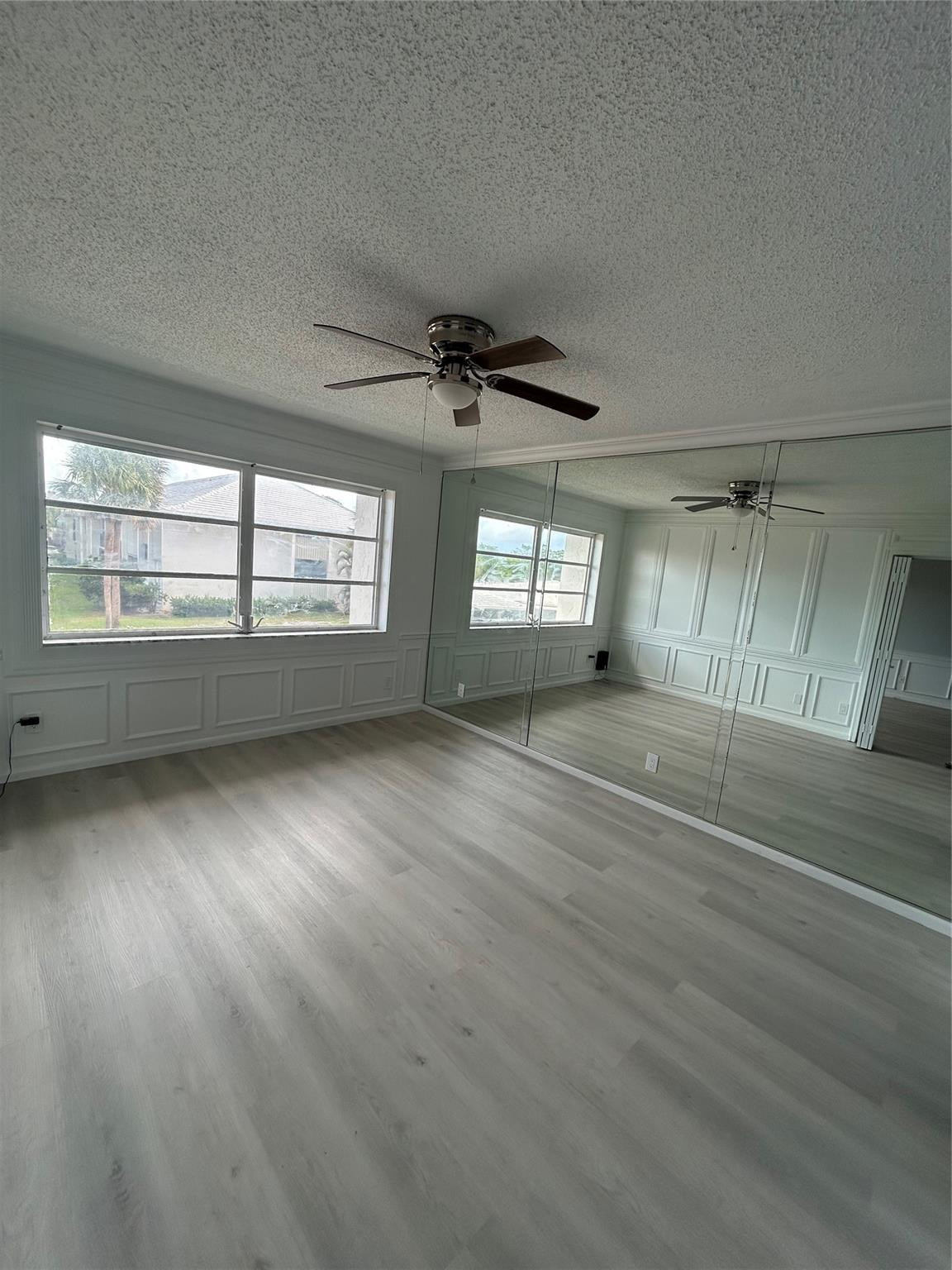 Huge Master Bedroom with wall to wall custom ( wainscoting) wood work, wall to ceiling Mirrors with tons of closet space ( His and Hers) New flooring installed.