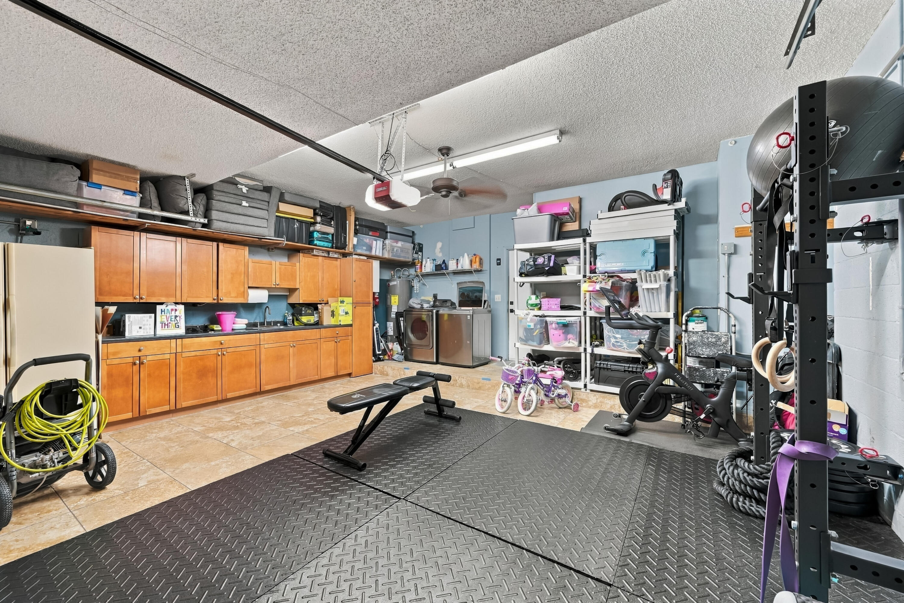 Builtin- cabinetry & storage racks in garage and still accomodates 2 cars!