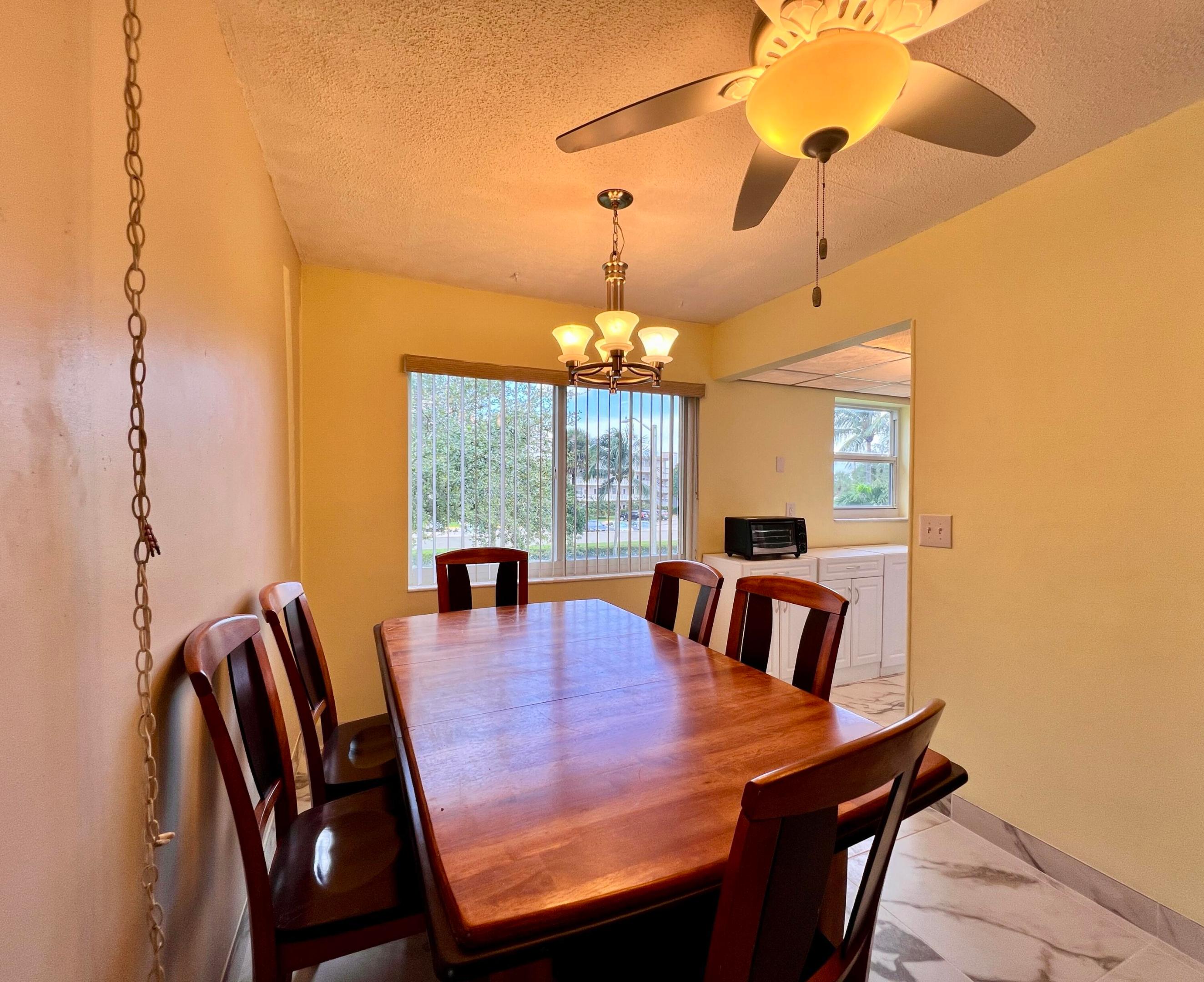 Lovely & Bright CORNER 2/1.5 Condo With Central AC and Gorgeous Large Format Tile Flooring Throughout!