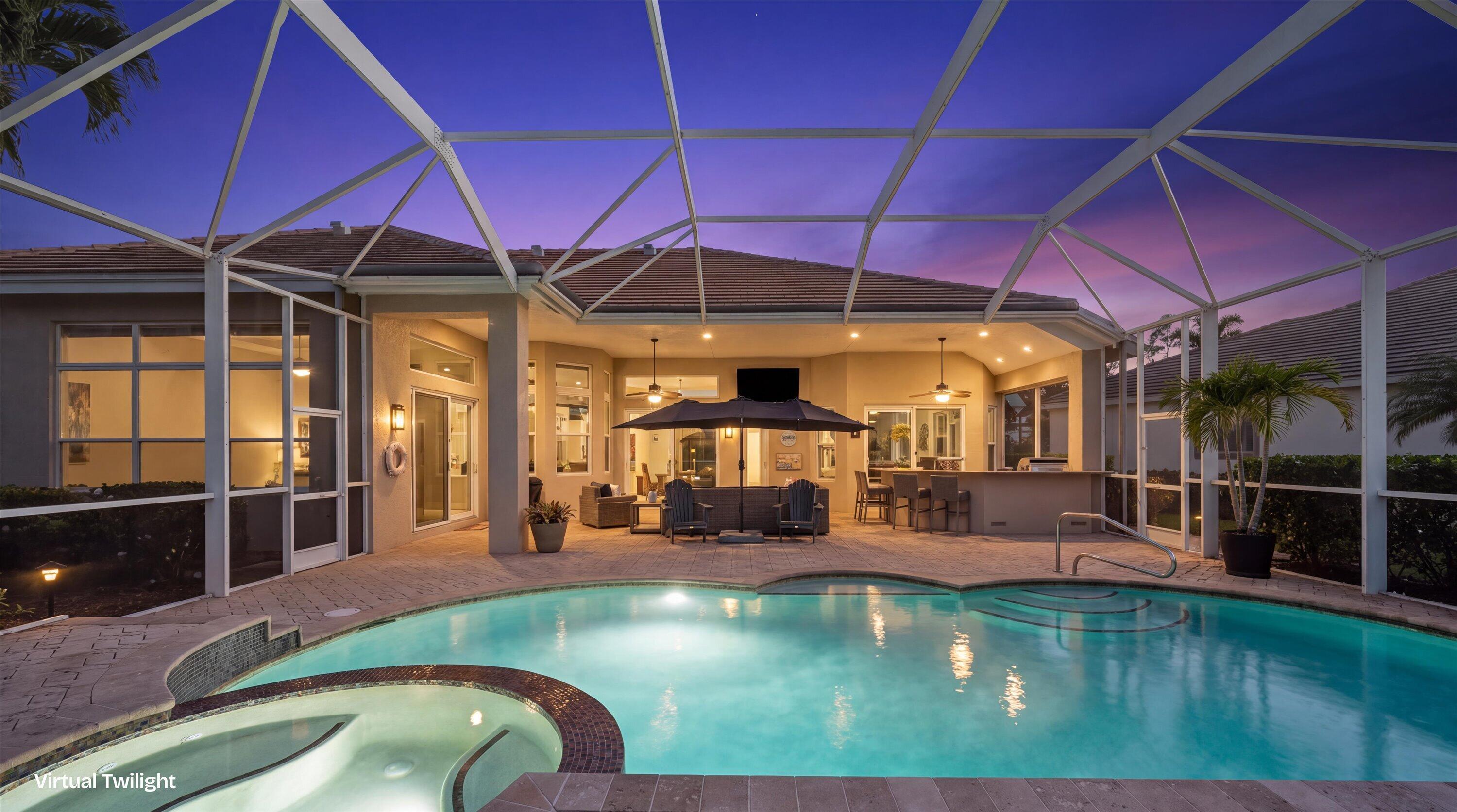 Screened lanai featuring a paver patio, integrated swimming pool with spa, and outdoor bar