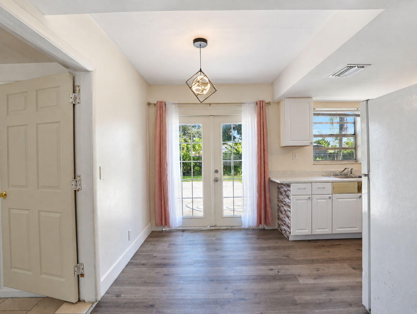 Dining room with French doors opening to the backyard