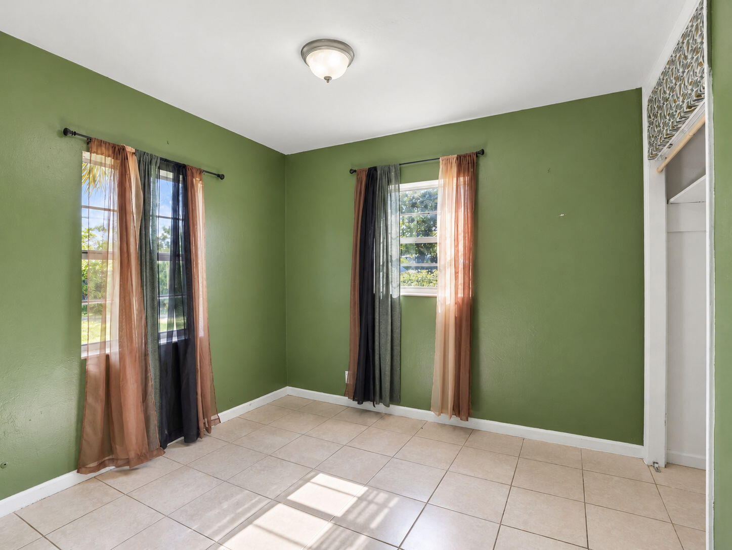 Room featuring light-toned tile flooring,