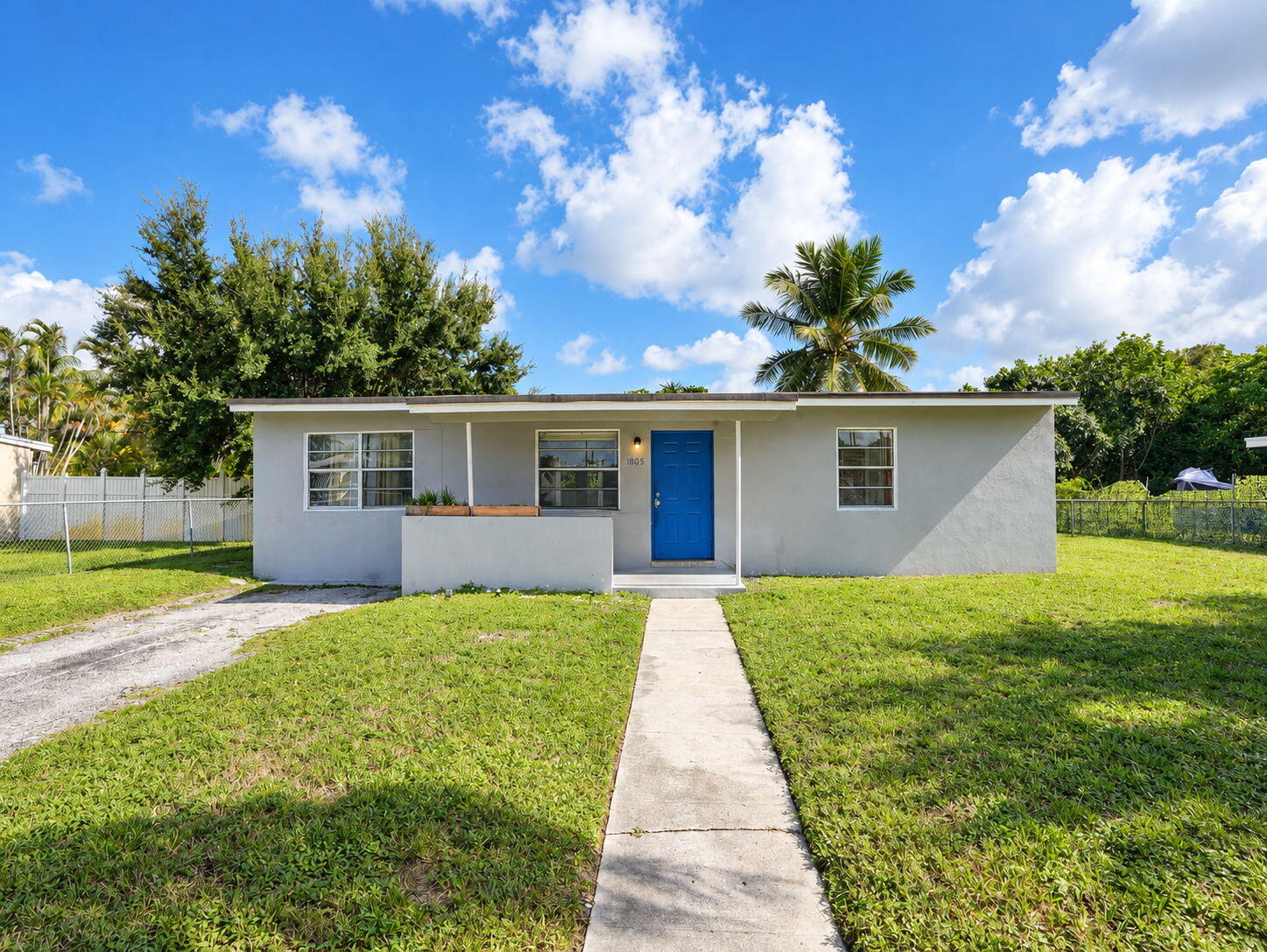 Single-story exterior featuring a concrete walkway, covered entryway