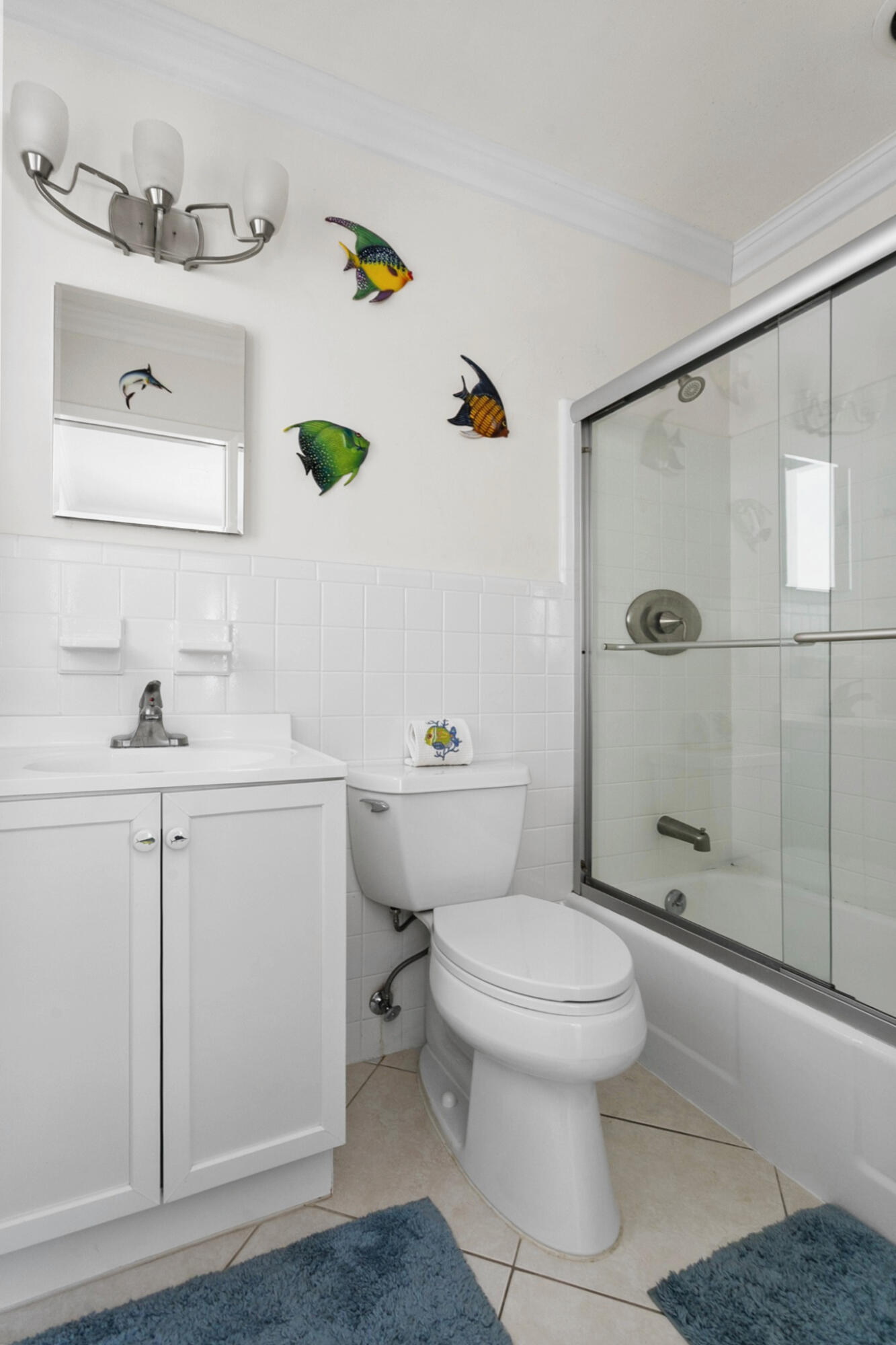 En-suite Guest Bathroom featuring a white vanity cabinet, square undermount sink, brushed nickel hardware, and a shower-tub combination with sliding glass doors