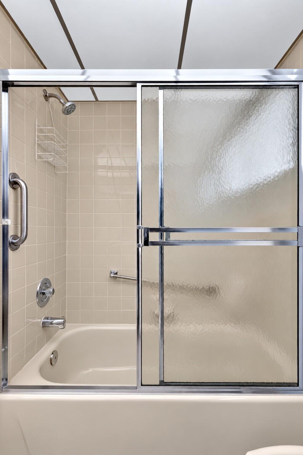 Clean Beige Tile Shower with Frosted Gla