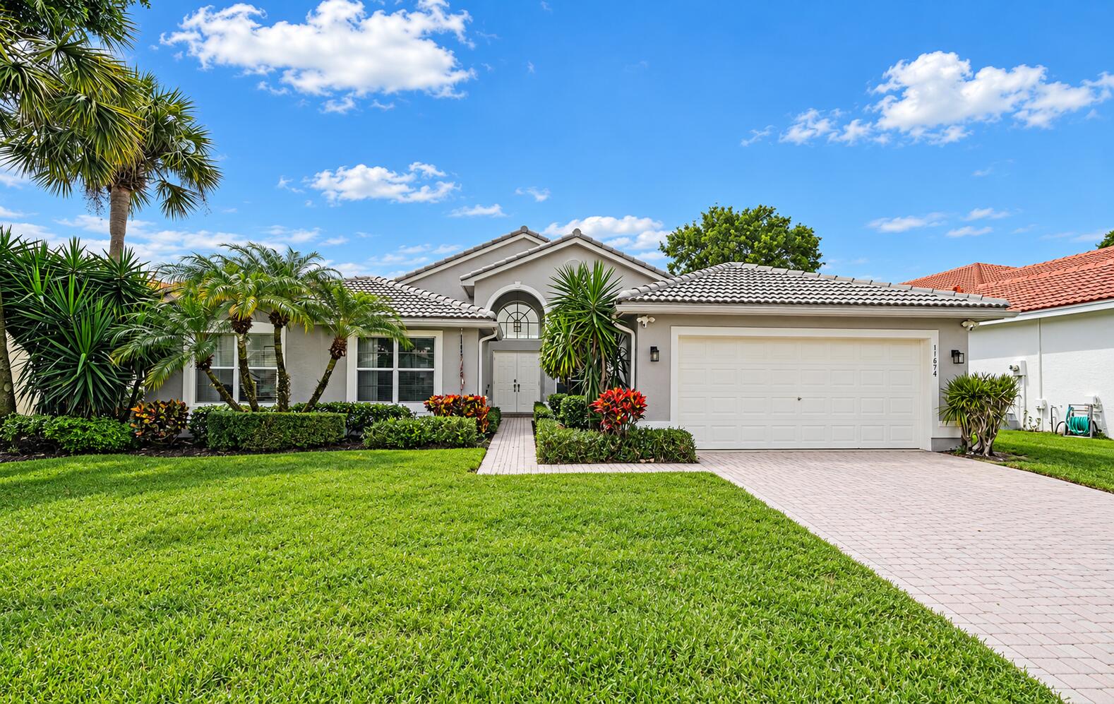 Mediterranean Suburban Home with Tropica