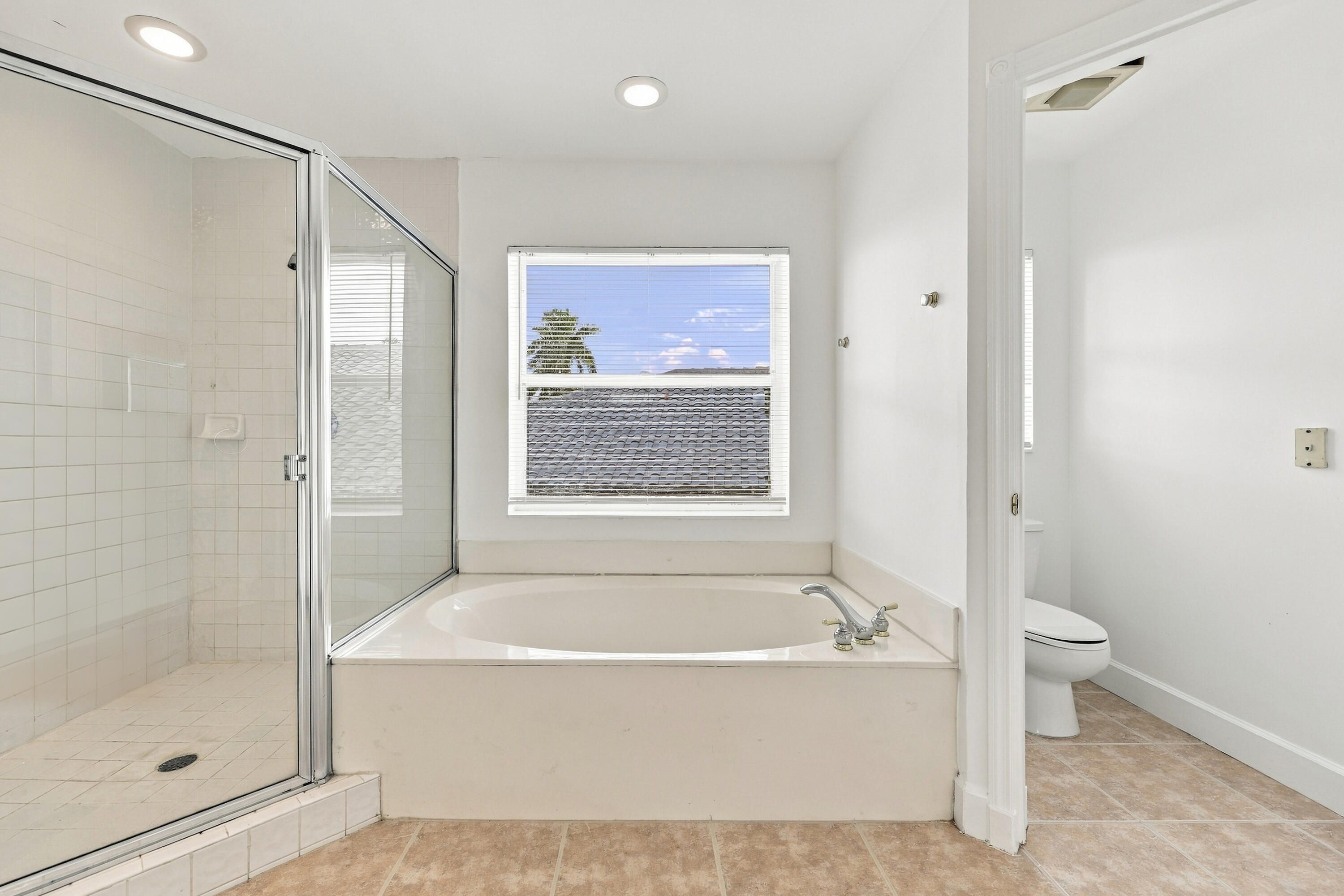 Enjoy the convenience of a separate soaking tub and oversized glass-enclosed shower, offering the perfect combination of comfort and functionality.