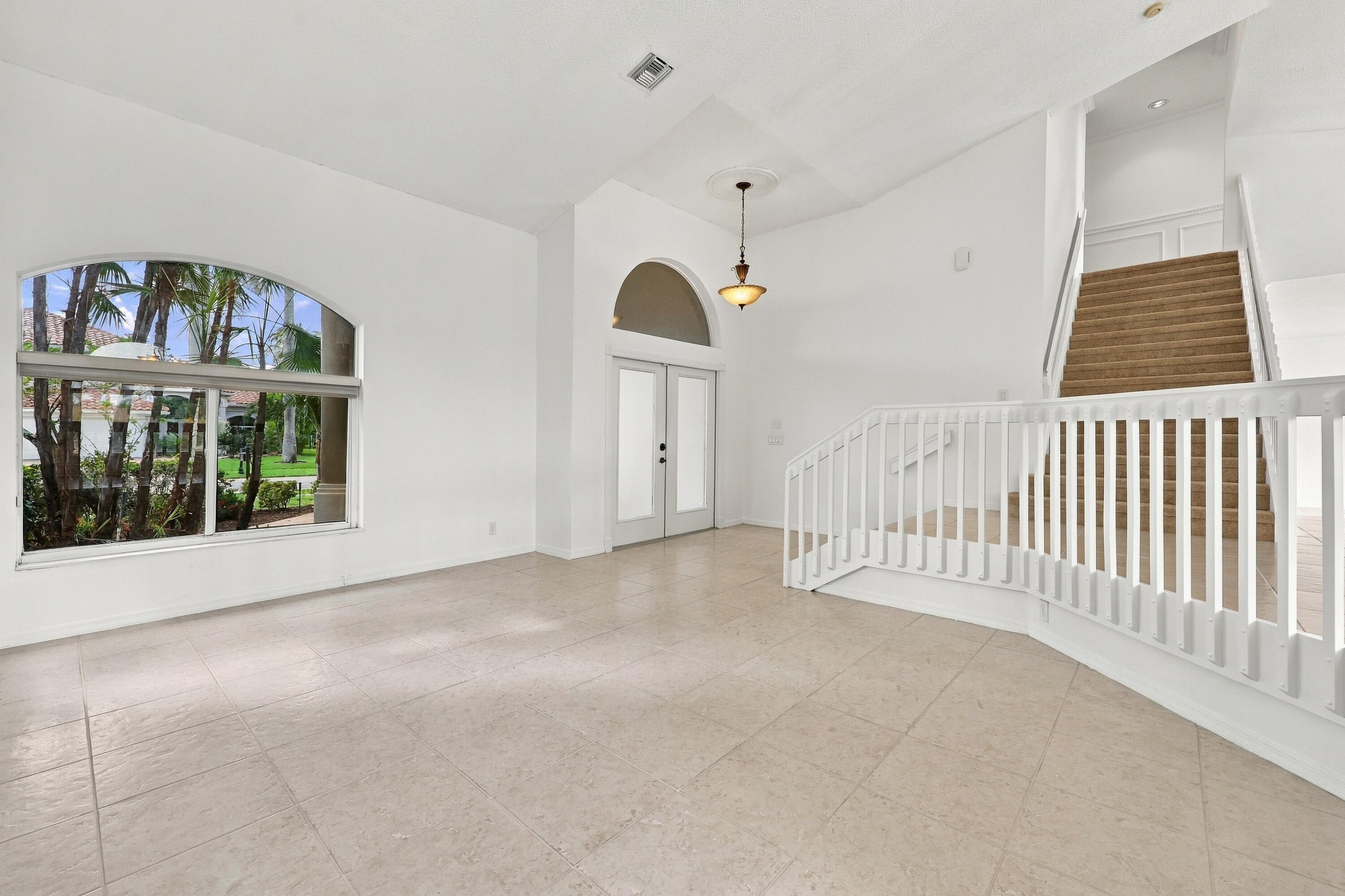 Impressive formal living room with dramatic vaulted ceilings, oversized arched windows, and an open, airy design that creates a wonderful first impression. Impressive formal living room with dramatic vaulted ceilings, oversized arched windows, and an open, airy design that creates a wonderful first impression.