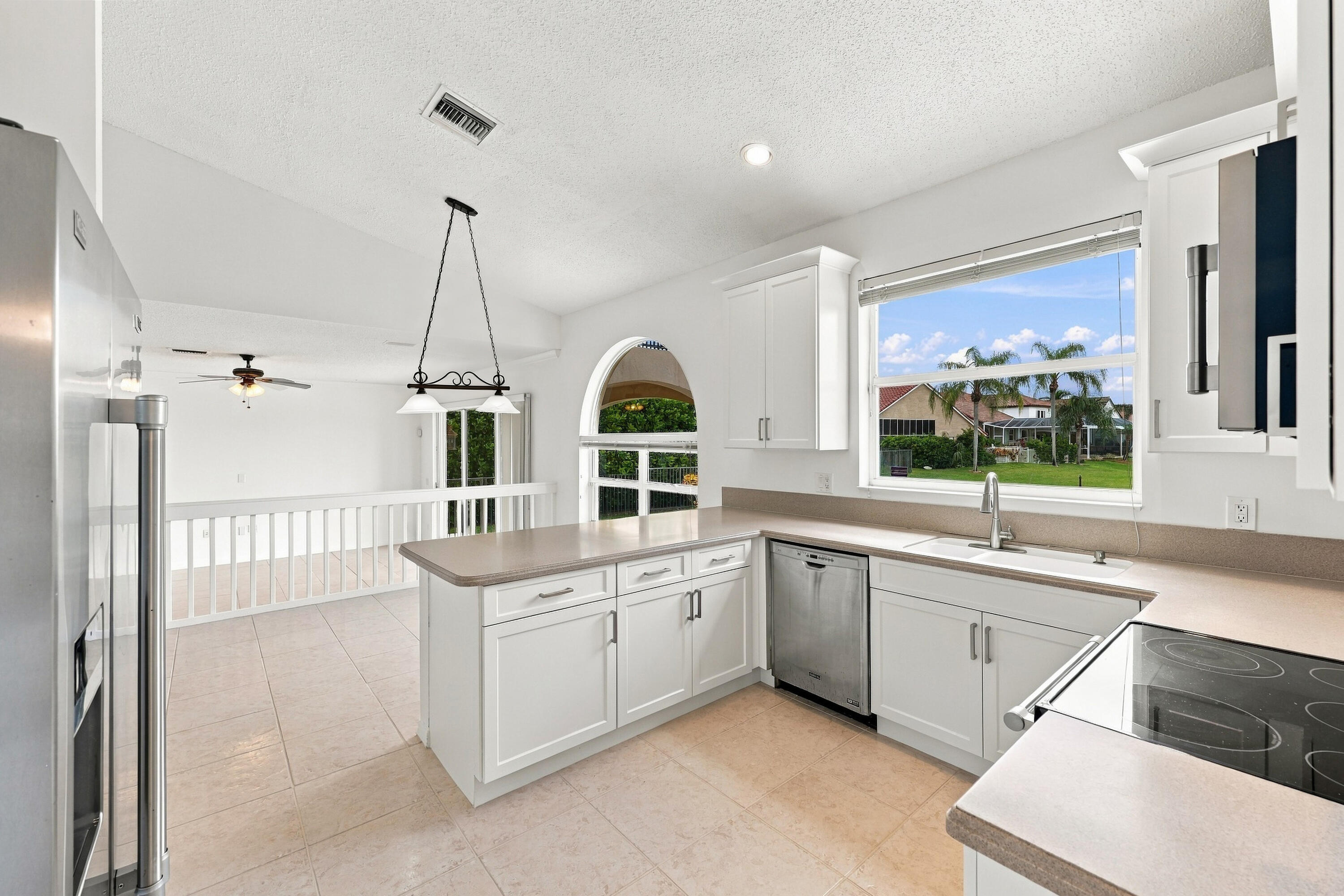 An expansive breakfast bar provides additional seating and preparation space, while the kitchen's open design allows for effortless interaction with the adjacent breakfast nook.