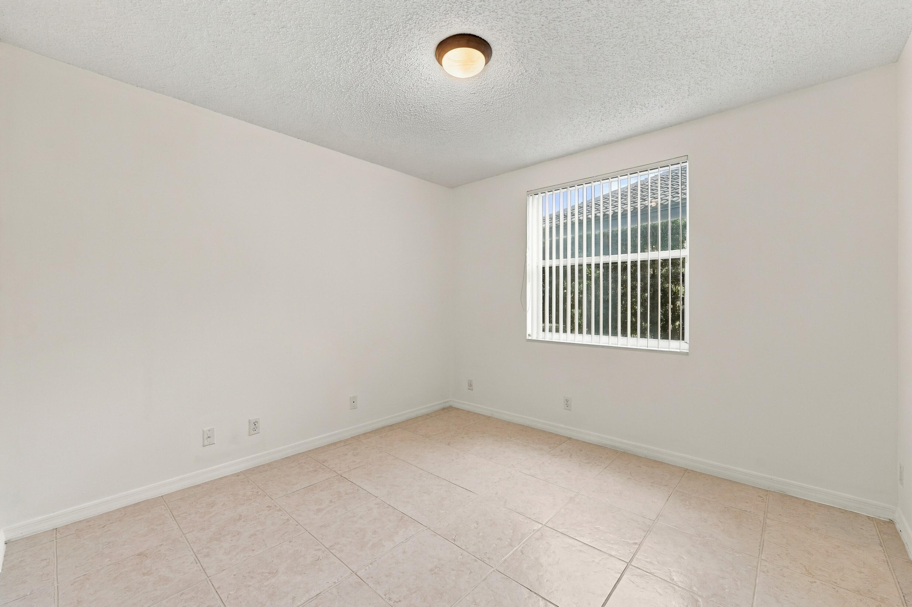 This well-appointed main-level bedroom offers flexibility for guests, a private office, or additional living space, with convenient access to the home's main living areas.