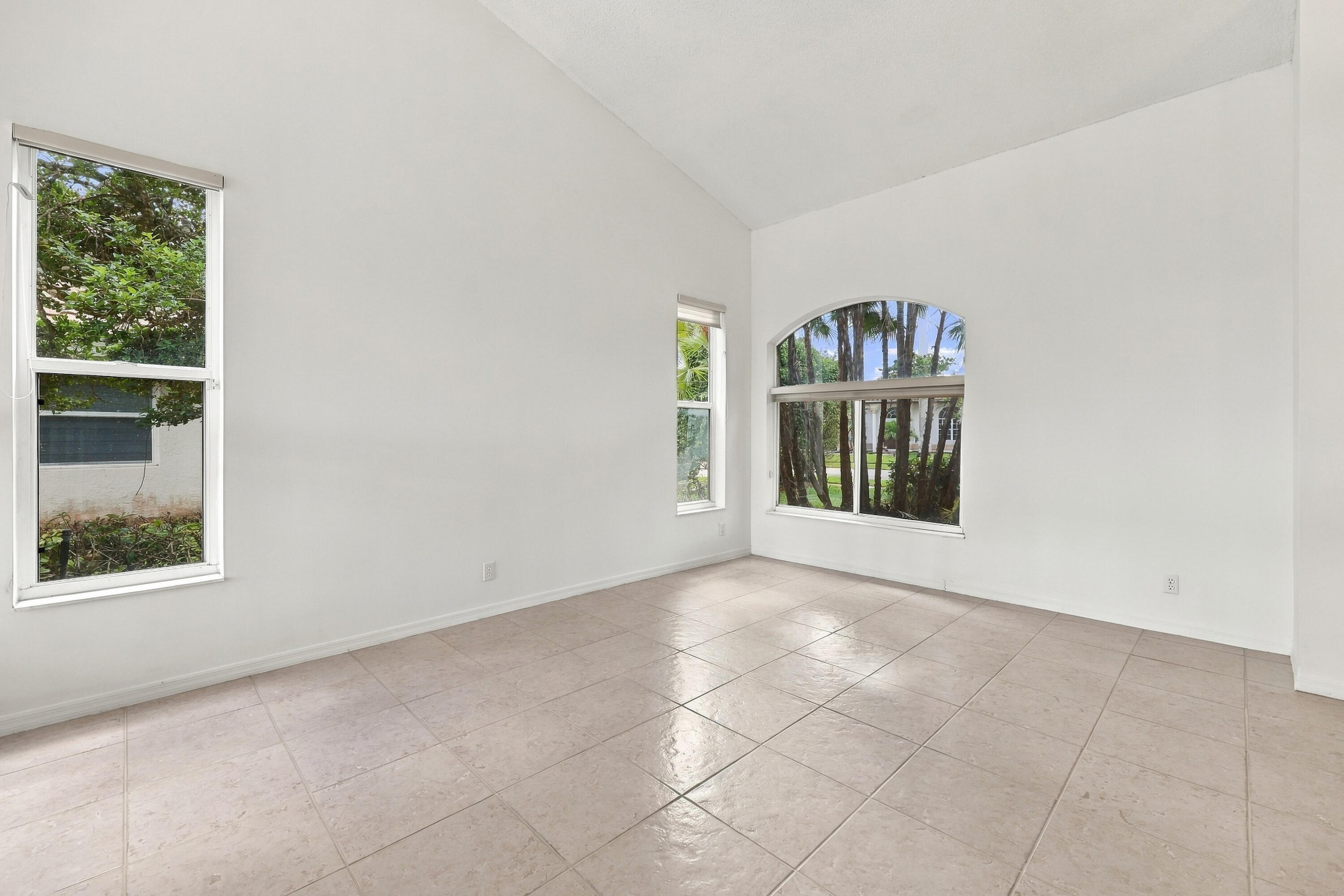 Soaring vaulted ceilings, expansive windows, and abundant natural light create a bright, inviting formal living room with an impressive sense of space. Soaring vaulted ceilings, expansive windows, and abundant natural light create a bright, inviting formal living room with an impressive sense of space.