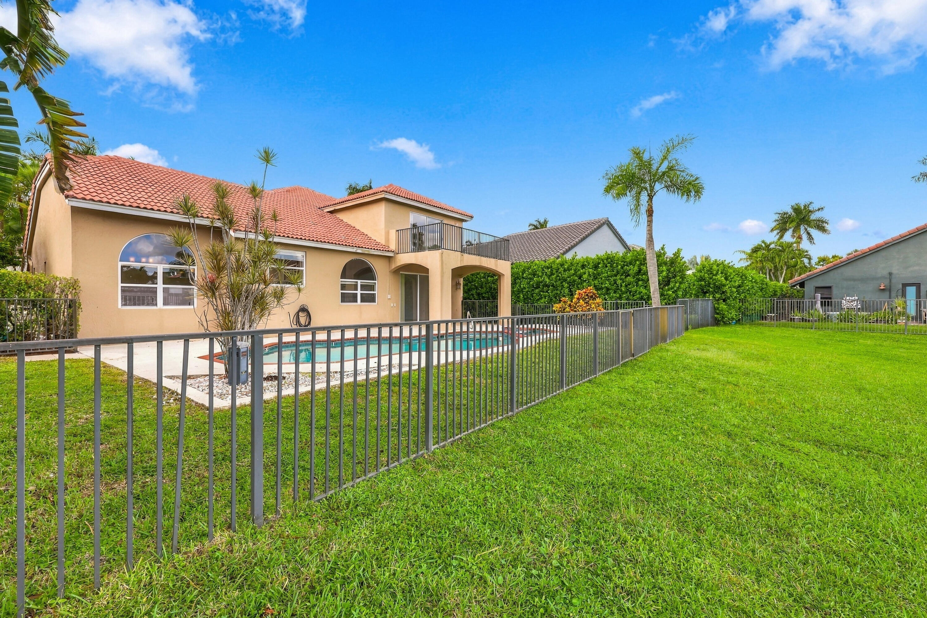 Privacy meets paradise! The fully fenced pool area, tropical landscaping, and peaceful waterfront setting offer the perfect combination of relaxation and outdoor living.
