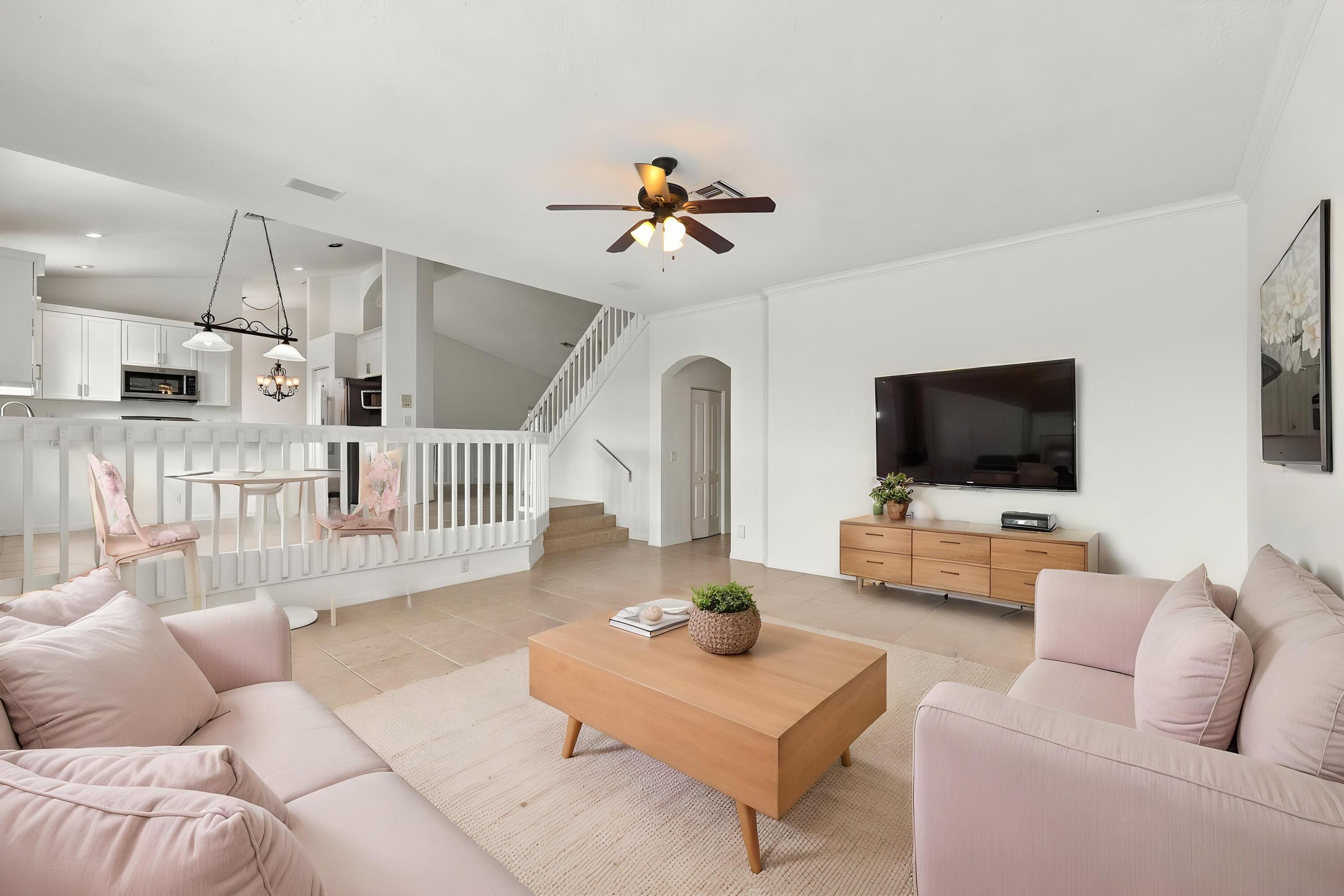 The generous formal living room offers soaring ceilings, an elegant chandelier, and an open design overlooking the home's grand entryway.