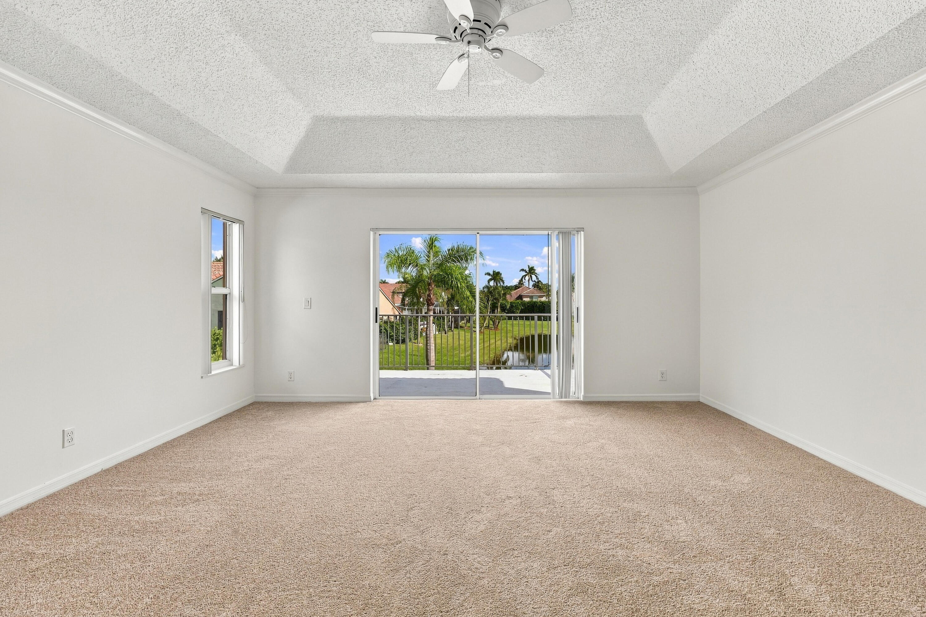 Wake up to beautiful waterfront views! Sliding glass doors open directly onto a private second-story balcony overlooking the tranquil lake and tropical surroundings.
