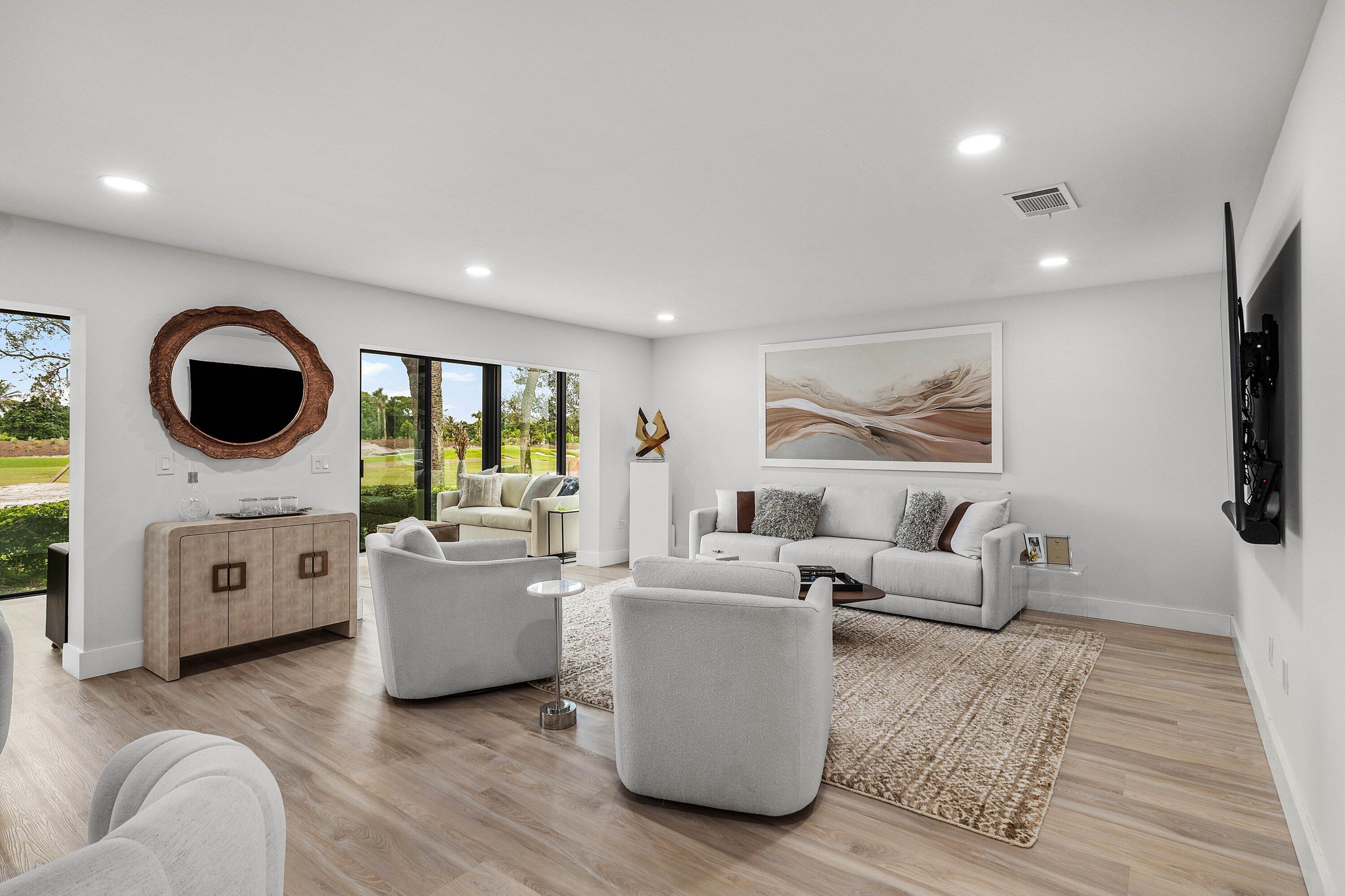 Living area featuring wood-finish flooring, recessed lighting, and large sliding glass doors